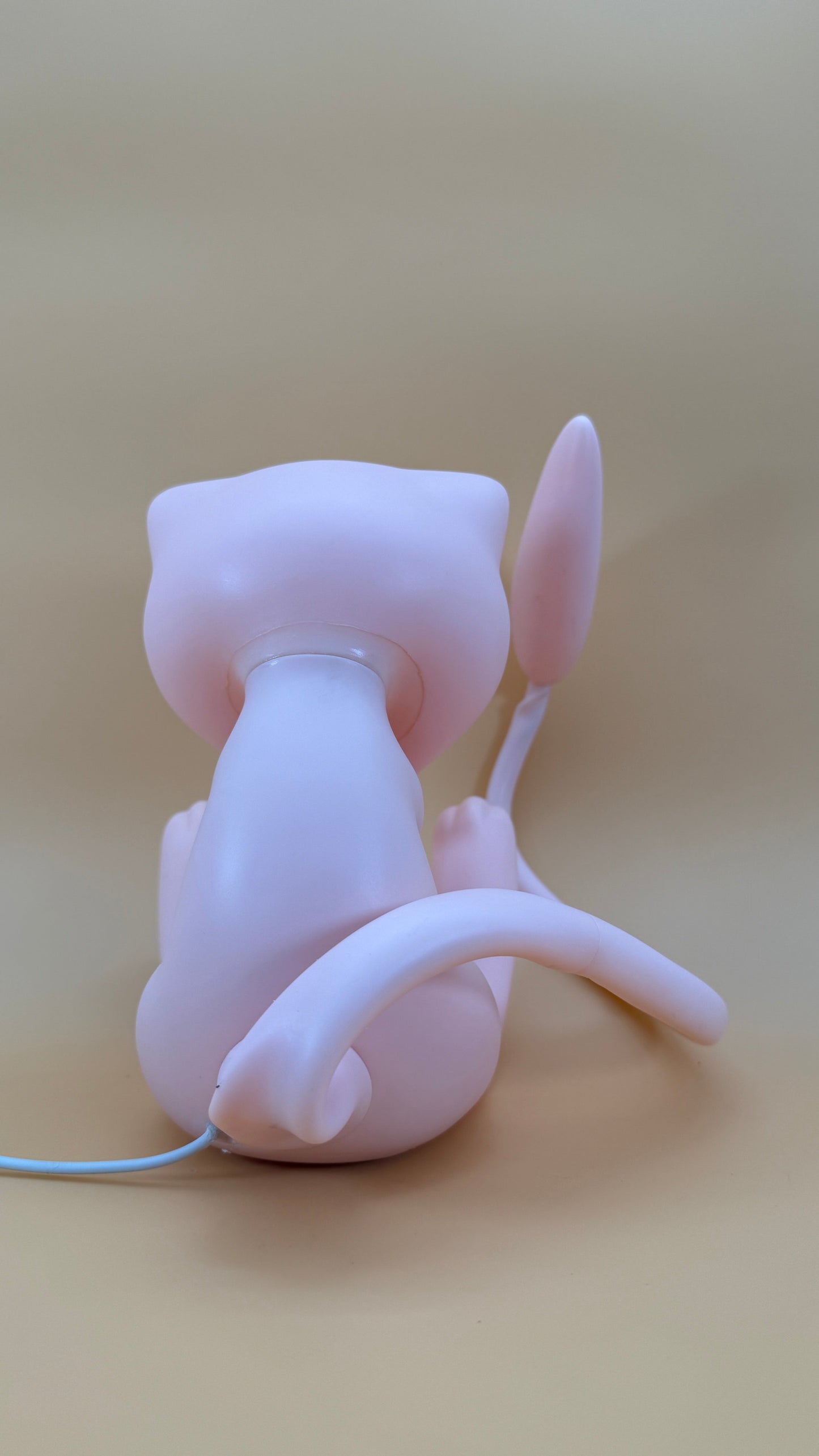 7.5” Mew with Movable Tail Pokemon Statue USB Desk Lamp Light on beige background.
