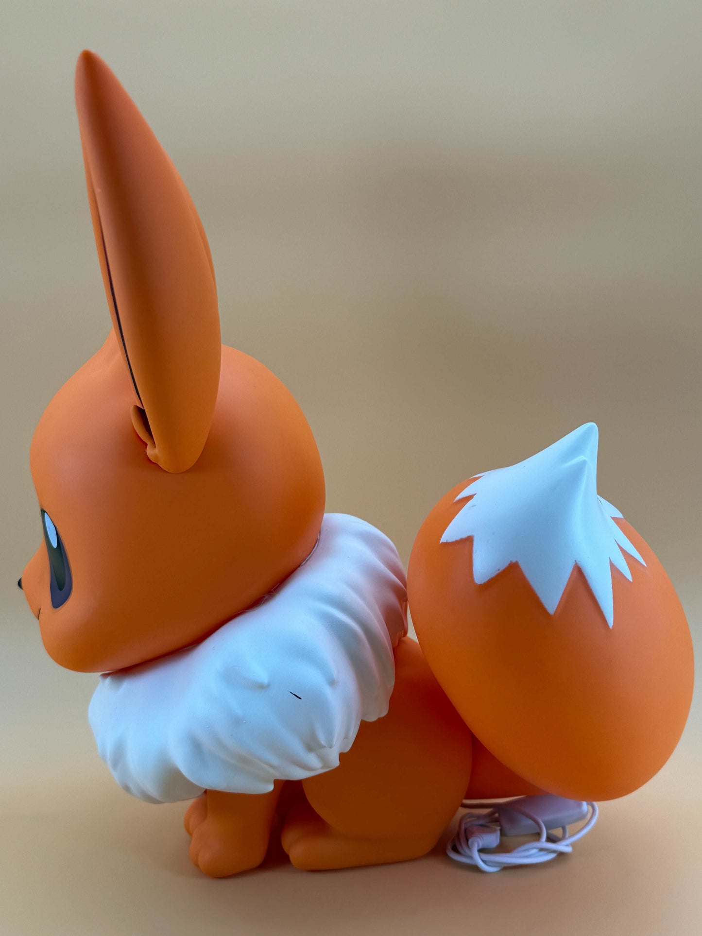 14.5" Eevee Large Statue USB Desk Lamp in orange, side view.