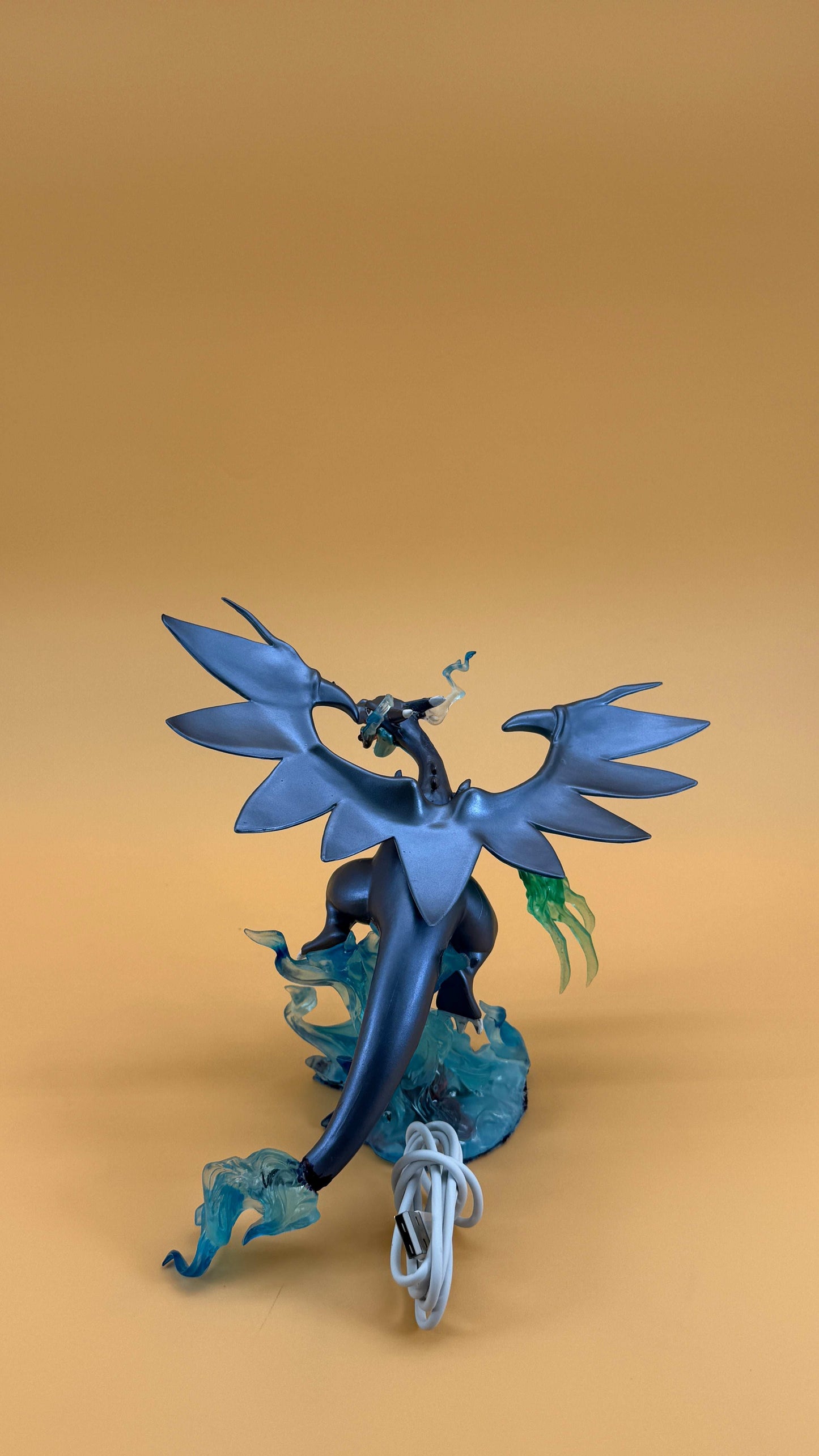 6" Mega Charizard X Pokemon statue USB desk lamp with wings and flames on a light brown background.