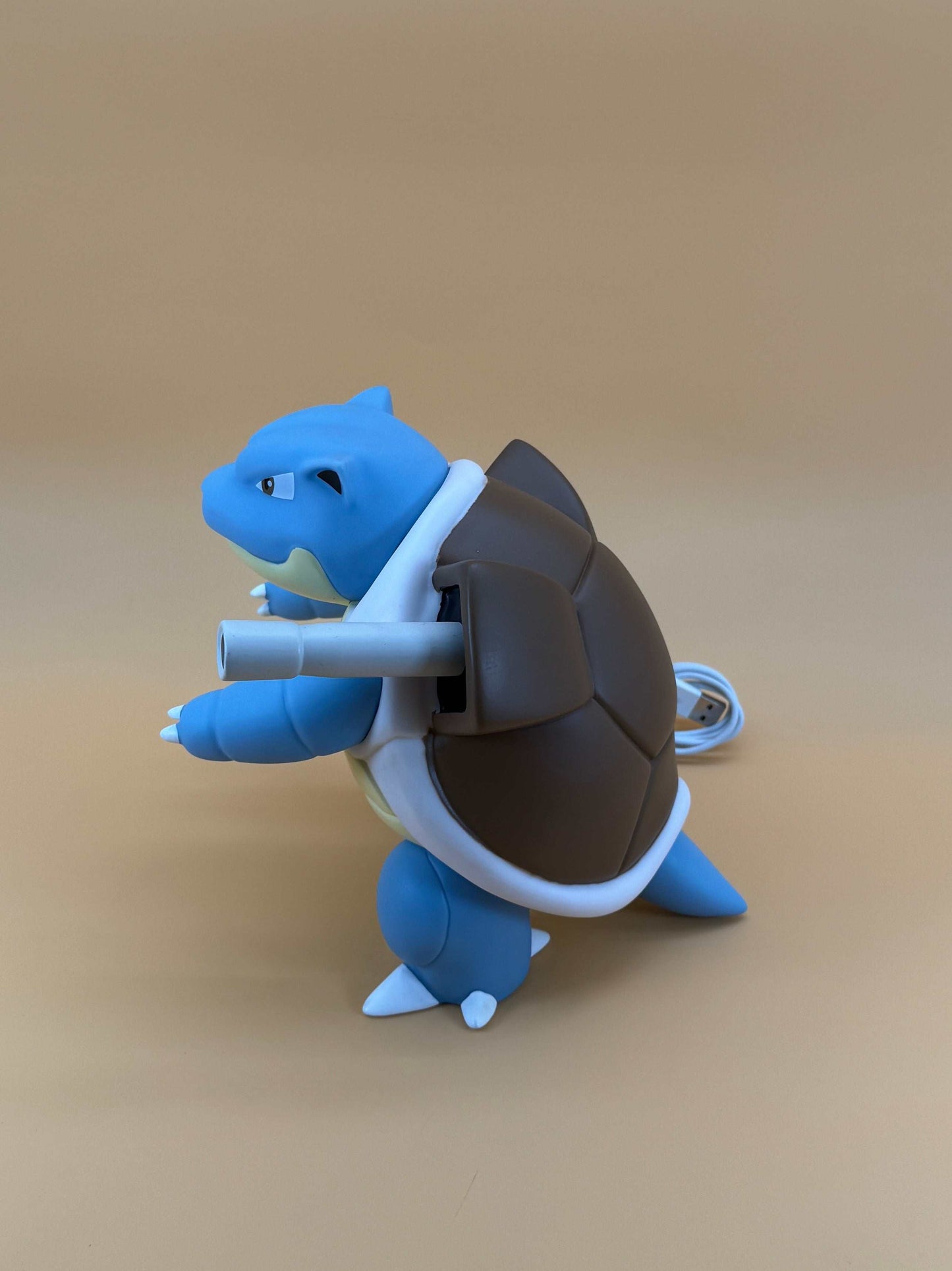 7" Blastoise Statue Pokemon USB Desk Lamp with built-in cord on a beige background.