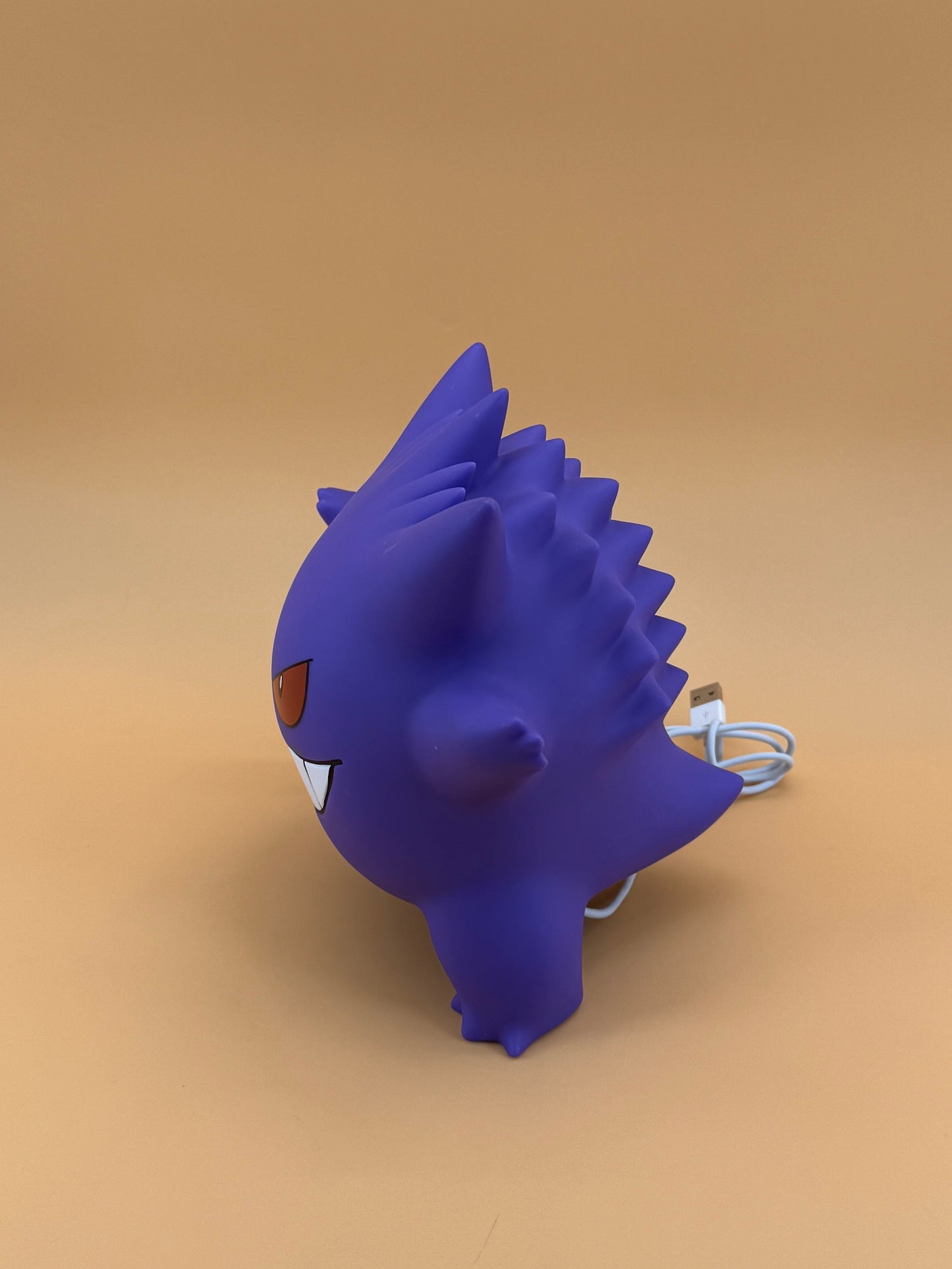 7" Gengar Statue USB Desk Lamp, purple collectible with built-in cord, side view.