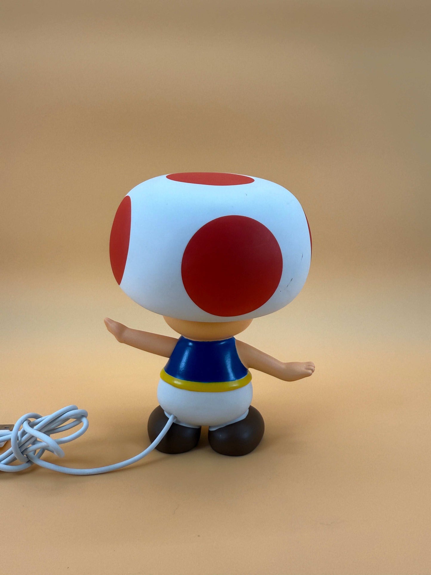 6" Nintendo Toad Statue USB Desk Lamp with built-in cord, shown from the back.