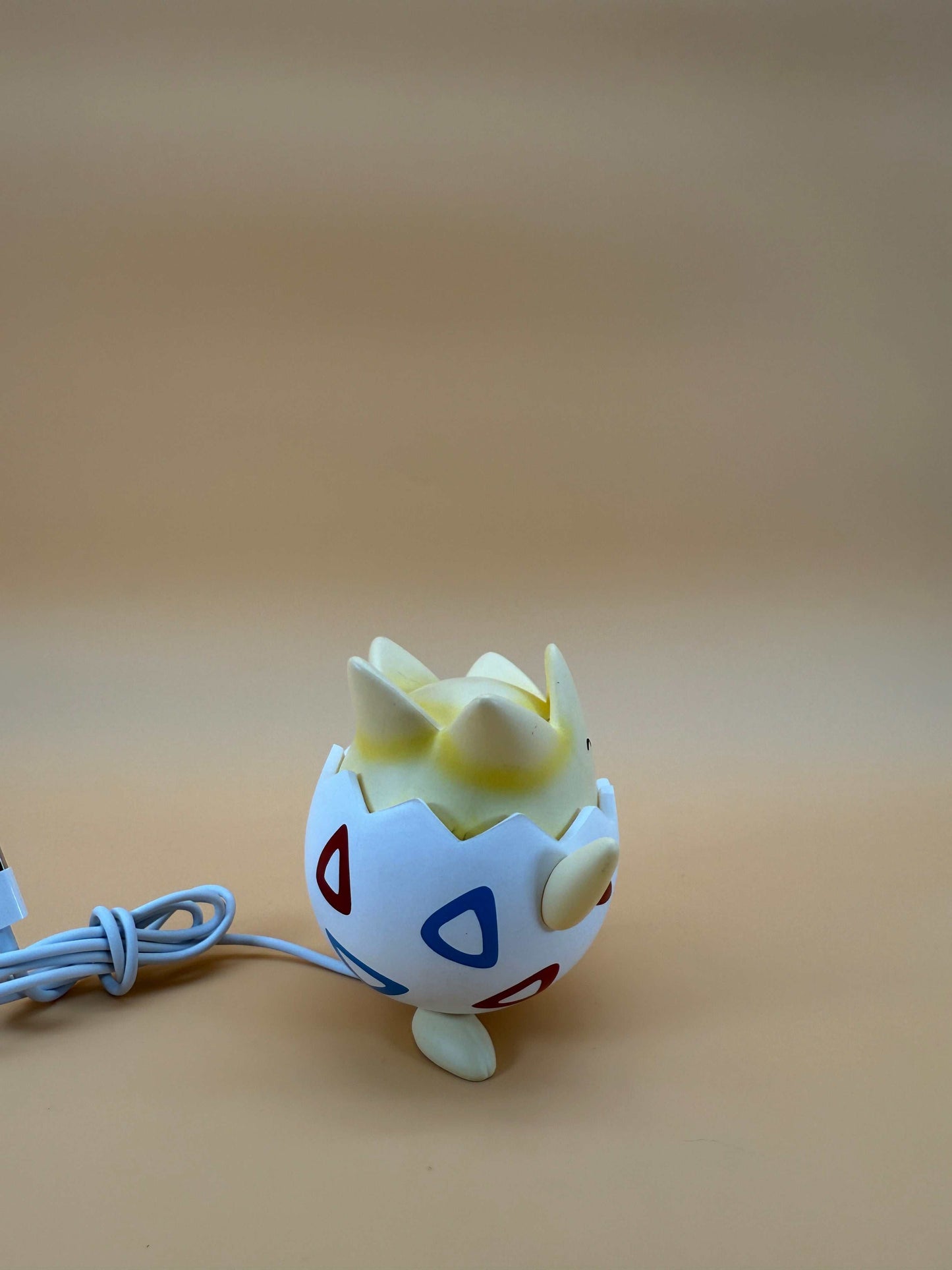 Togepi desk lamp USB light in egg-inspired design on beige background.