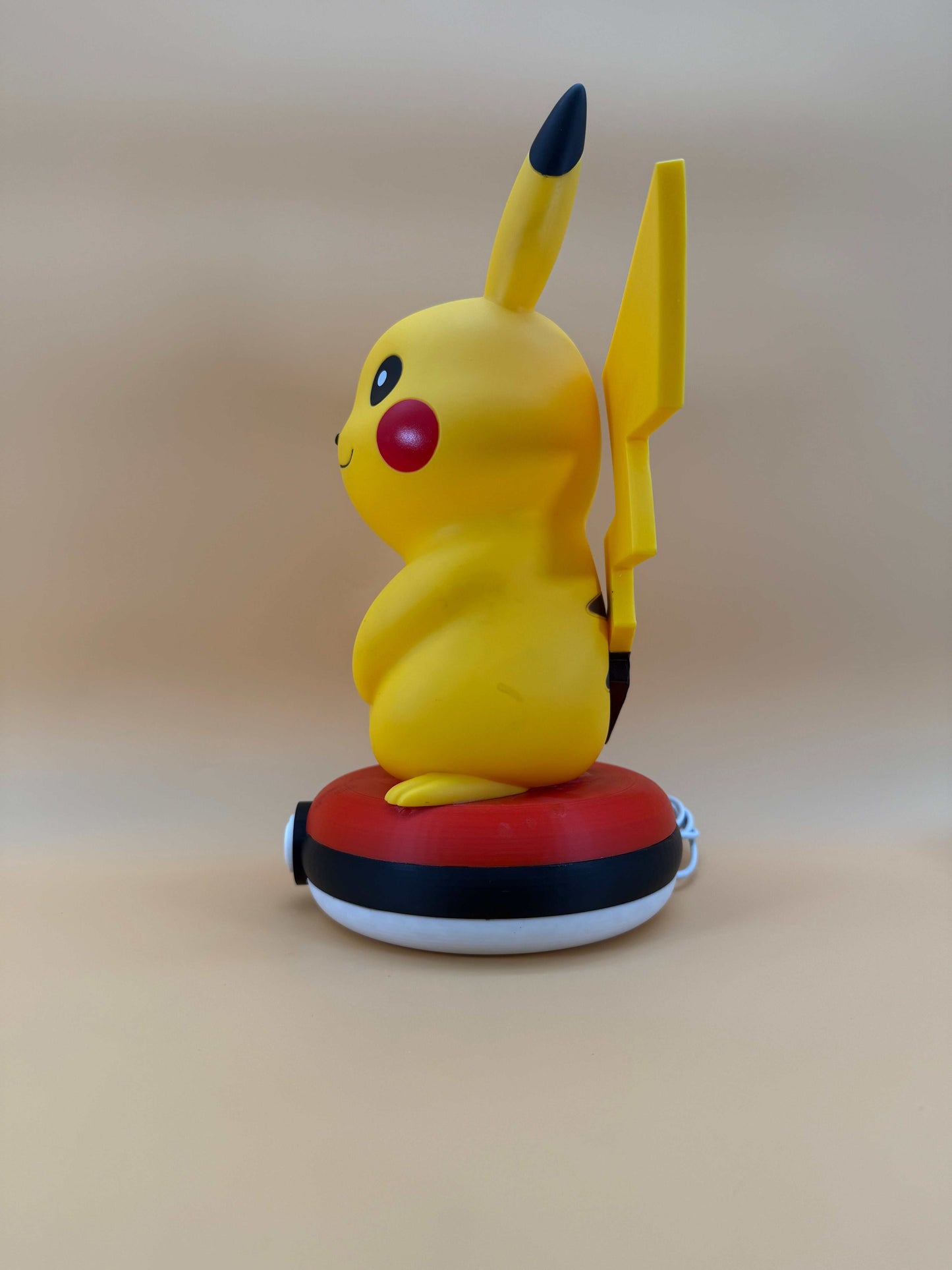 12” Pikachu Pokeball statue USB desk lamp with built-in cord, side view.