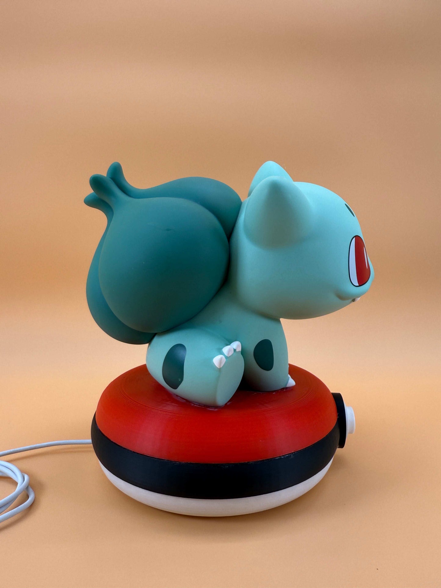 7" Bulbasaur Pokeball desk lamp with USB cord, featuring a unique and magical design.