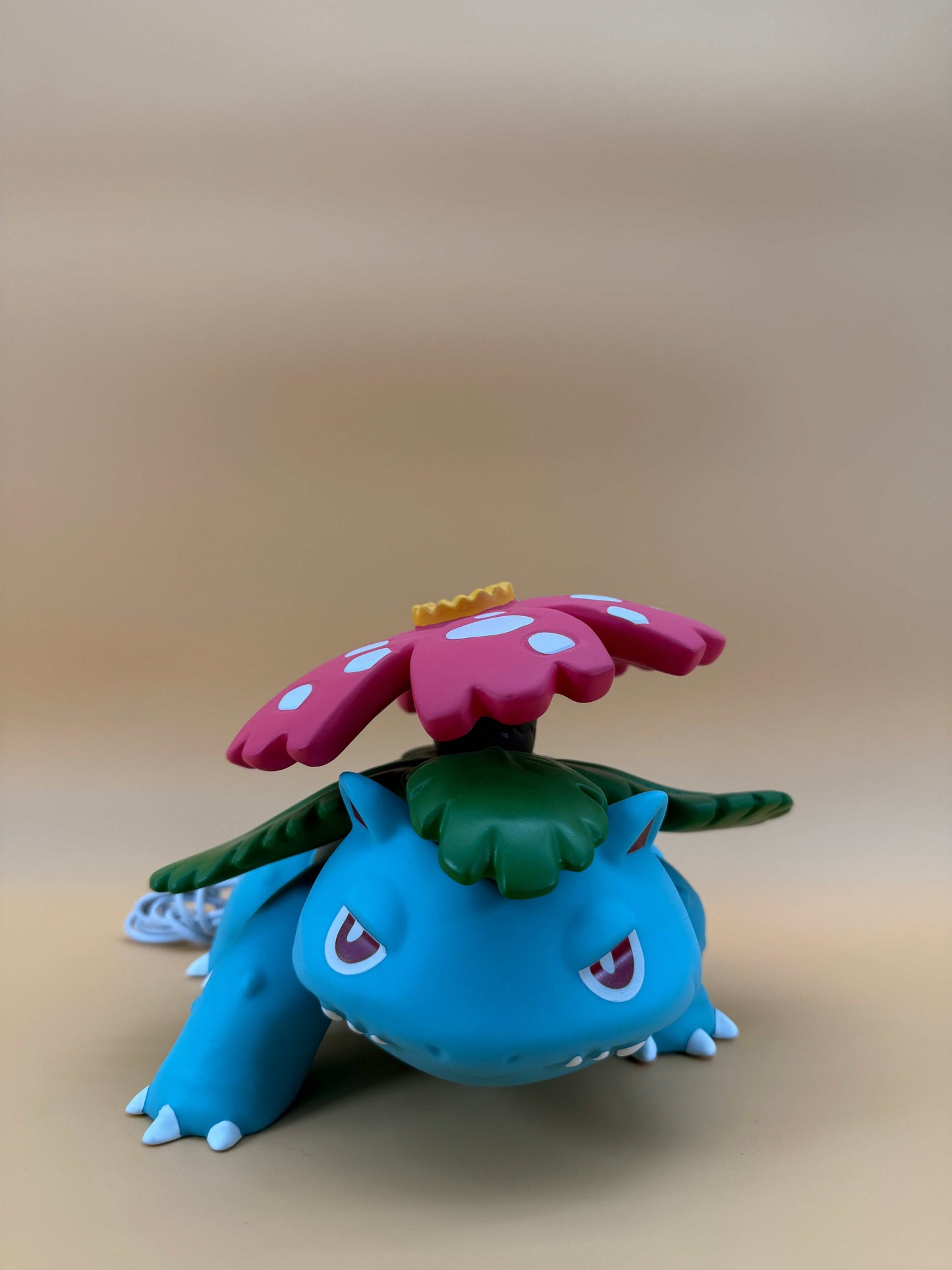 5" x 7" Venusaur statue desk lamp with built-in USB cord, featuring colorful design for unique decor.