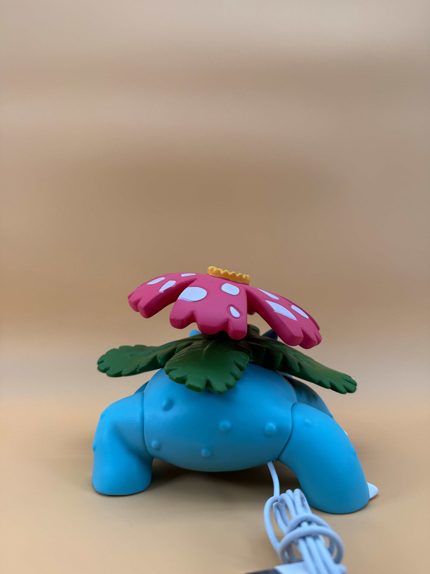 5" x 7" Venusaur statue desk lamp with USB cord, featuring a blue base and floral top.