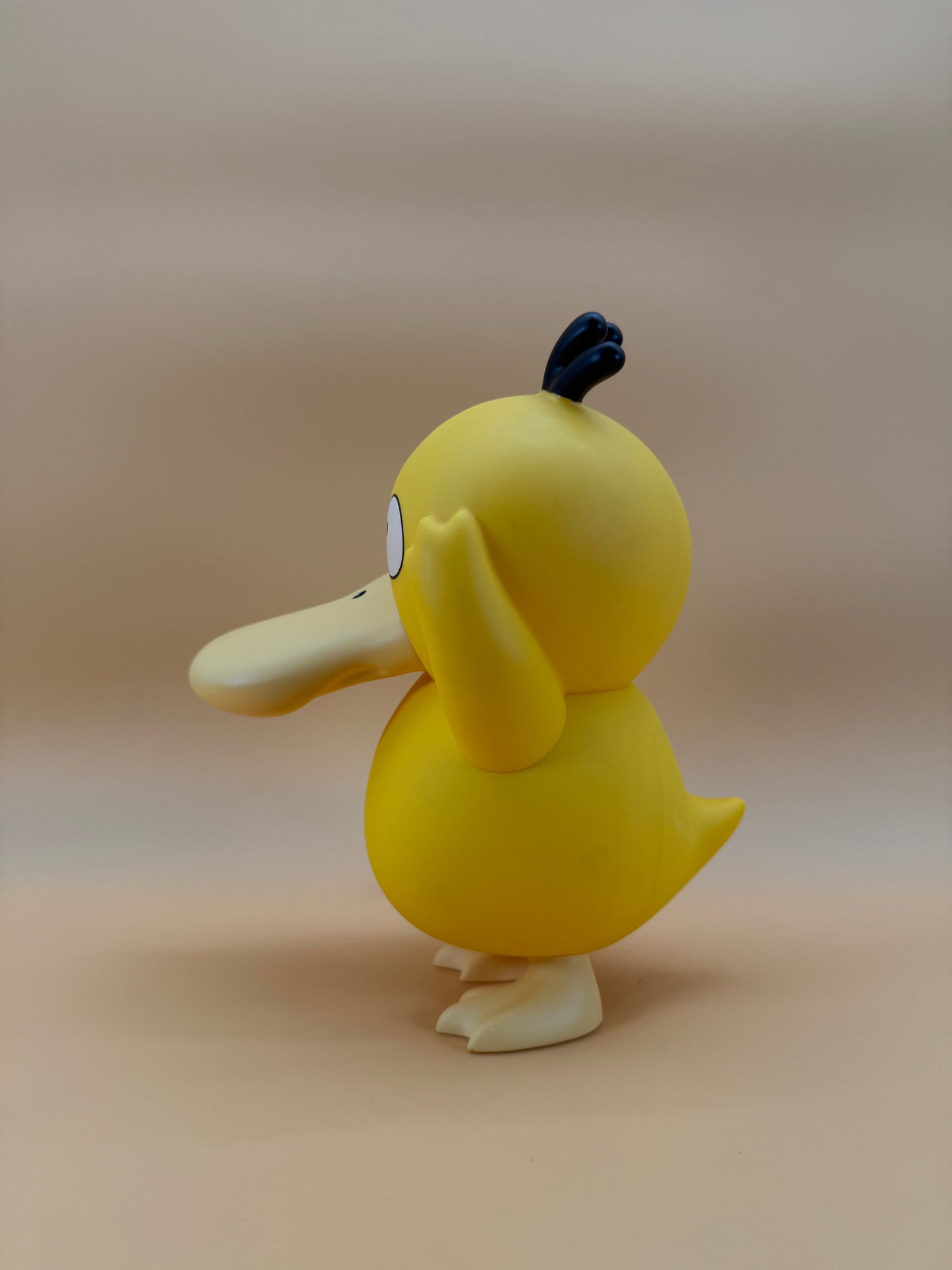 8" Psyduck Statue USB Desk Lamp Light in yellow, side view.
