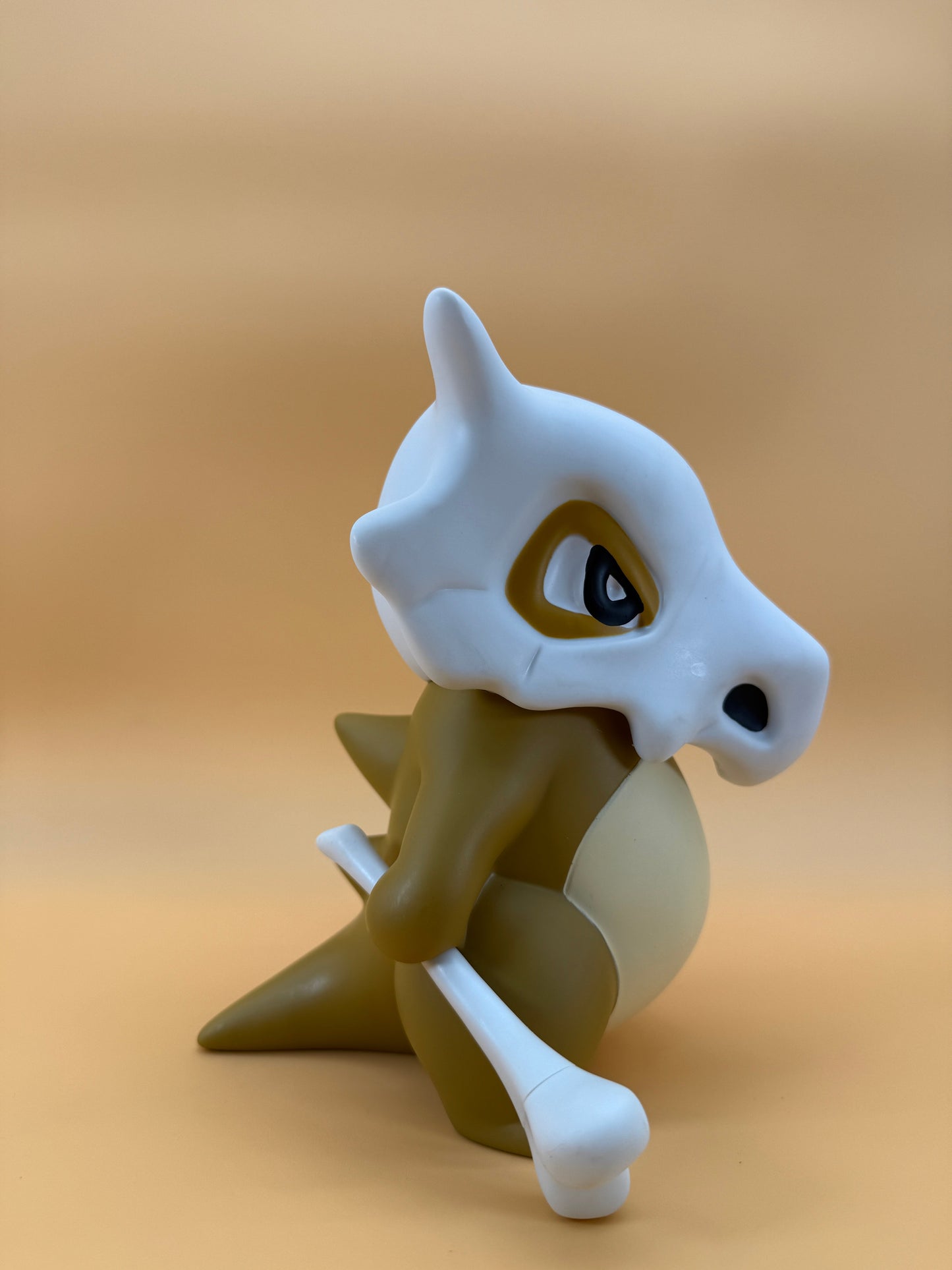 8" Cubone Statue Pokemon USB Desk Lamp in beige and white tones.