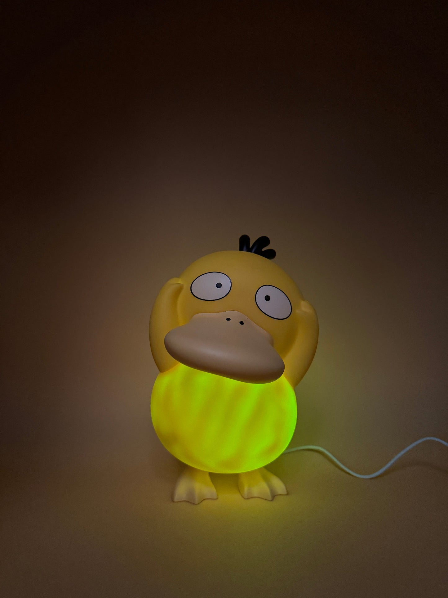 8" Psyduck Statue Desk Lamp with USB cord, glowing light.