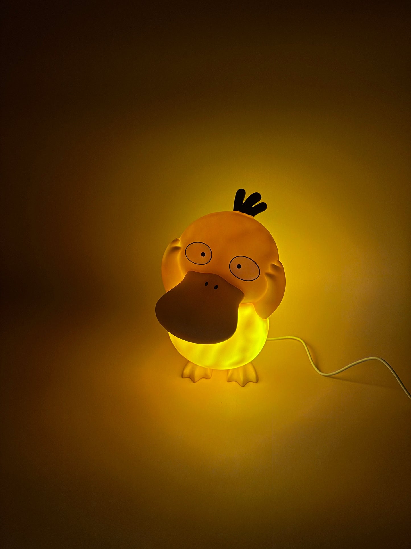 8" Psyduck Statue USB Desk Lamp Light, glowing in warm ambiance.