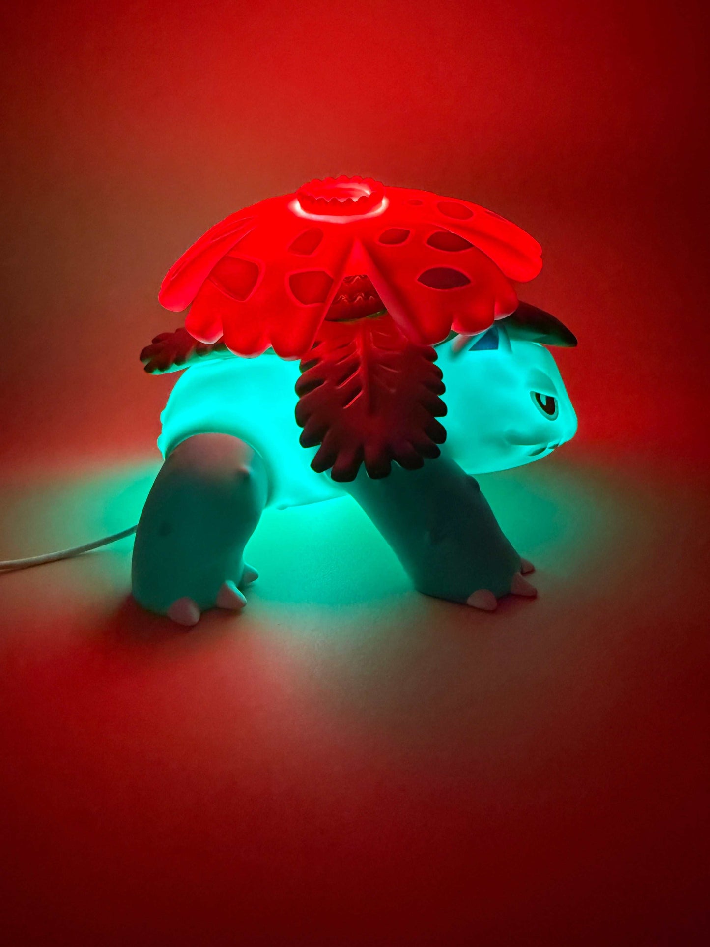 5" x 7" Venusaur statue USB desk lamp illuminating in red and blue tones.