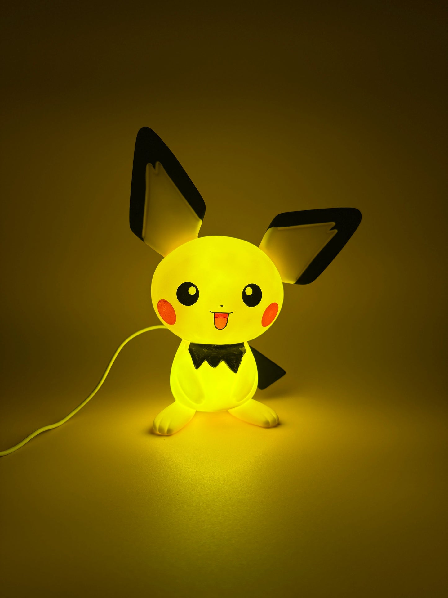 8.5" Pichu Statue USB Desk Lamp illuminating softly.