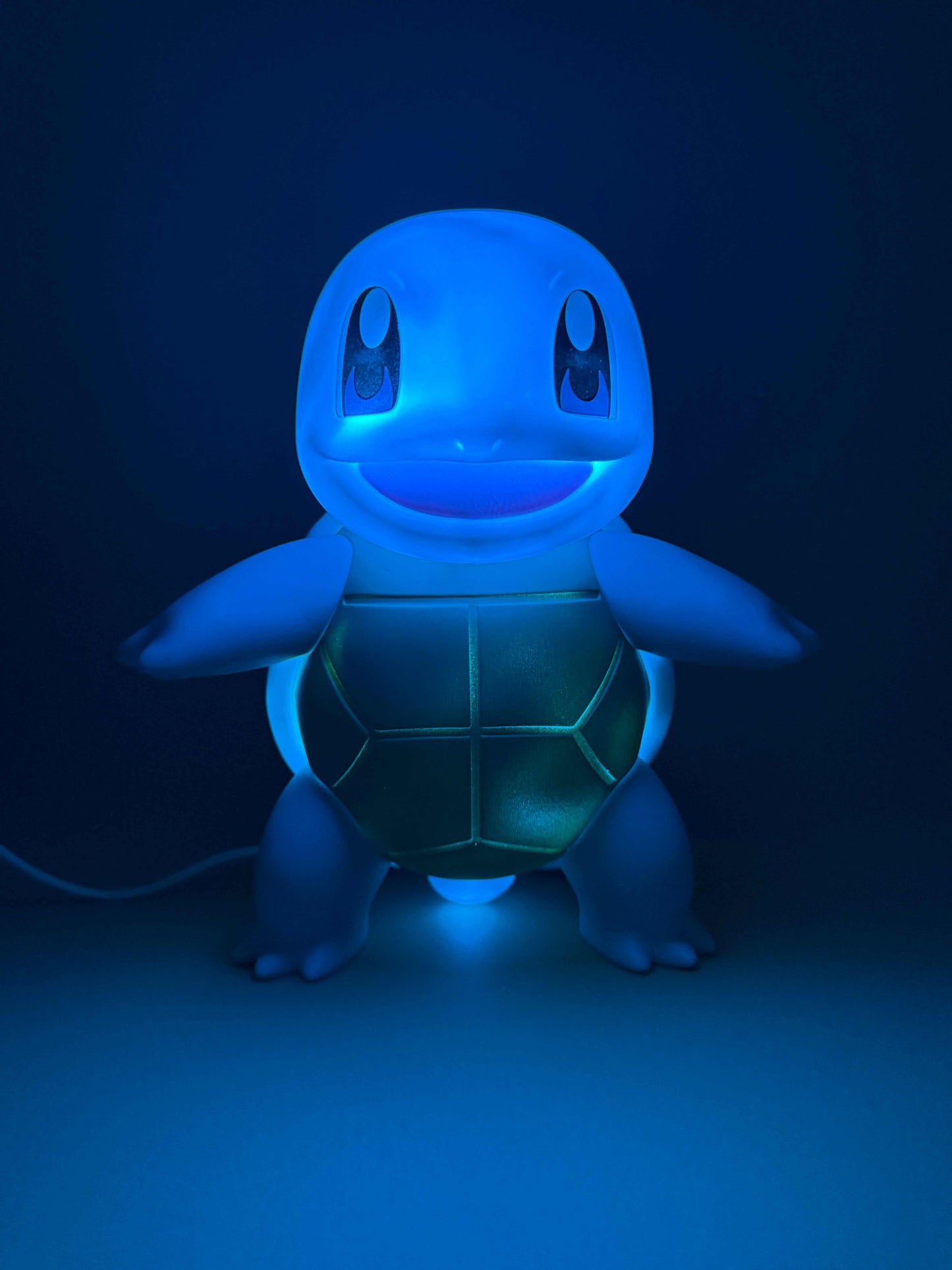 7.8" Squirtle Statue USB Desk Lamp glowing in blue light.