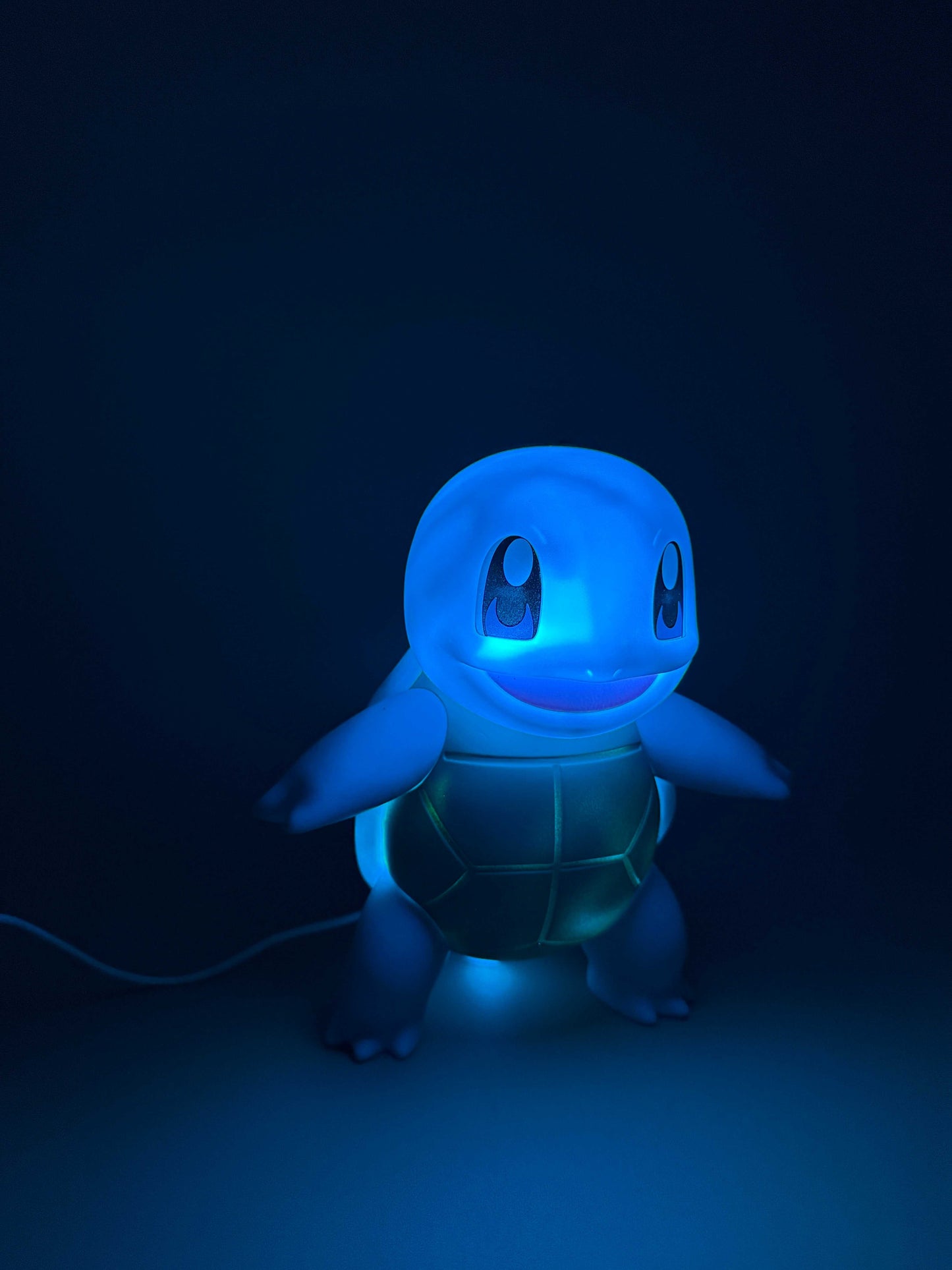7.8" Squirtle Statue USB Desk Lamp glowing in blue light.