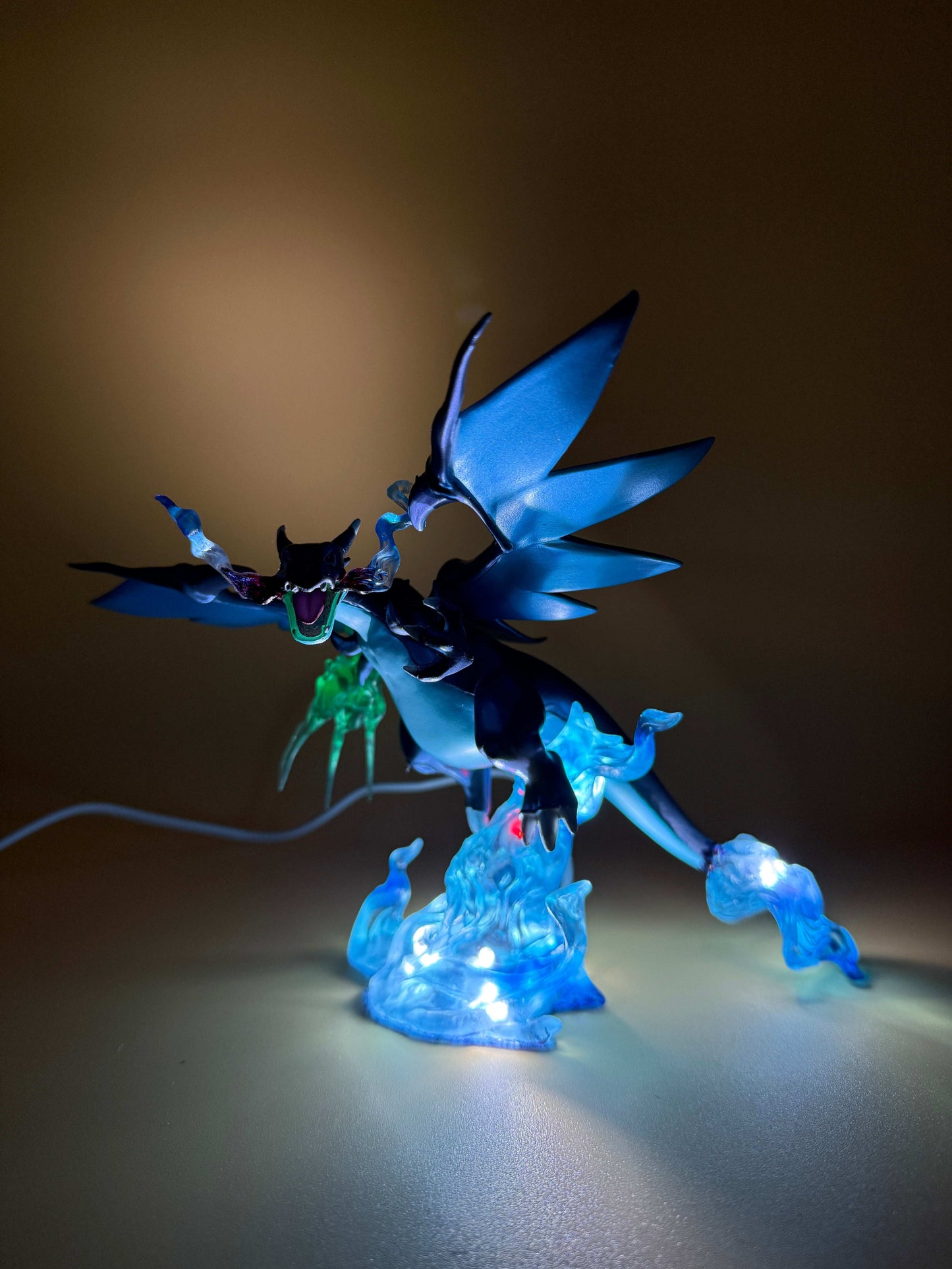 Mega Charizard X Pokemon statue USB desk lamp with blue LED lighting and built-in USB cord.