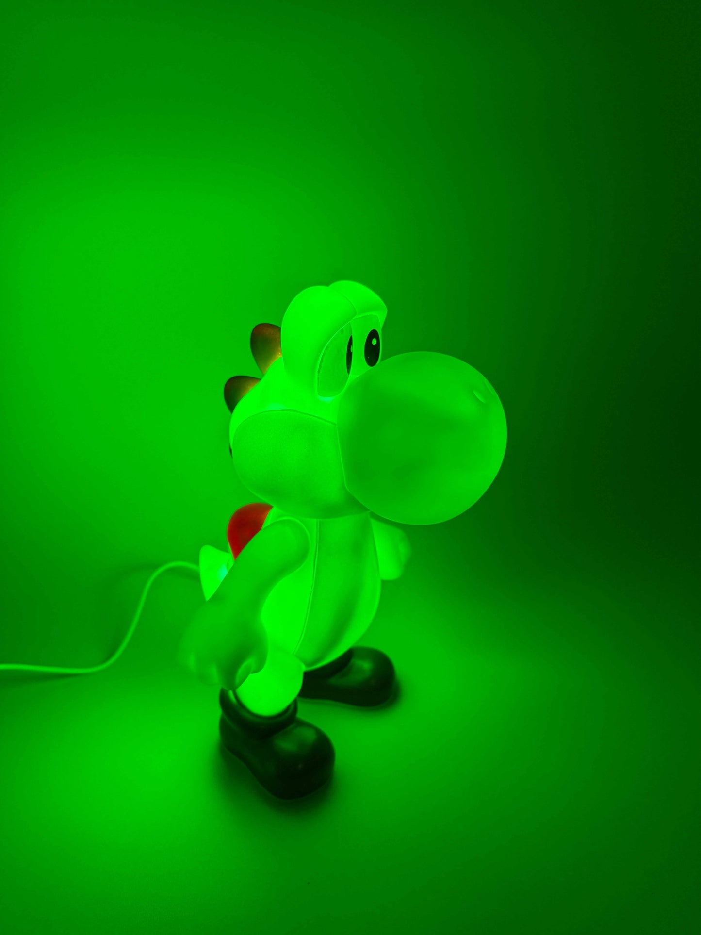 9" Yoshi desk lamp with USB cord glowing green, adding a magical touch to any space.
