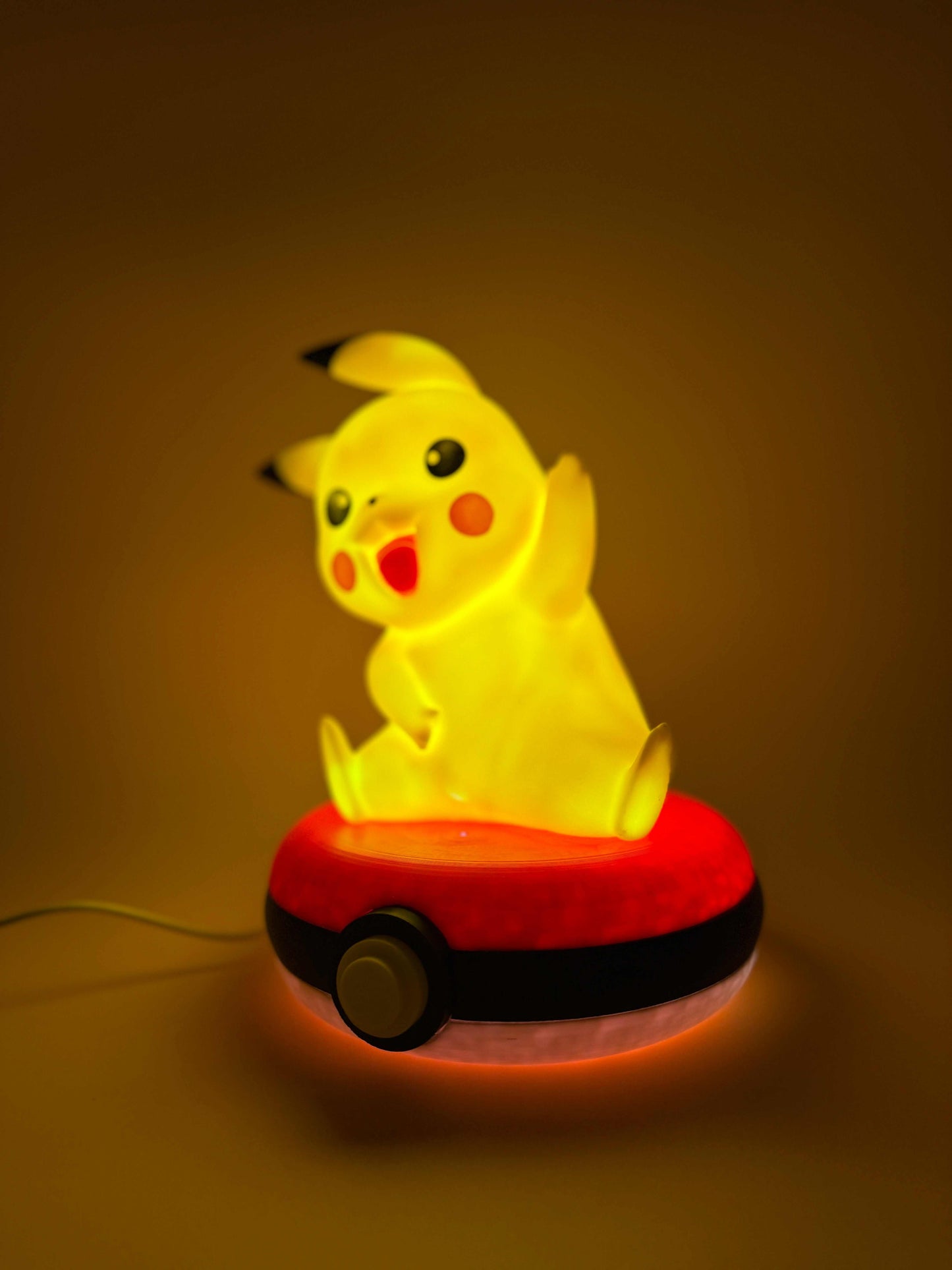 8" Pikachu Pokeball Desk Lamp with USB, illuminating yellow light, perfect for adding a magical touch to any space.