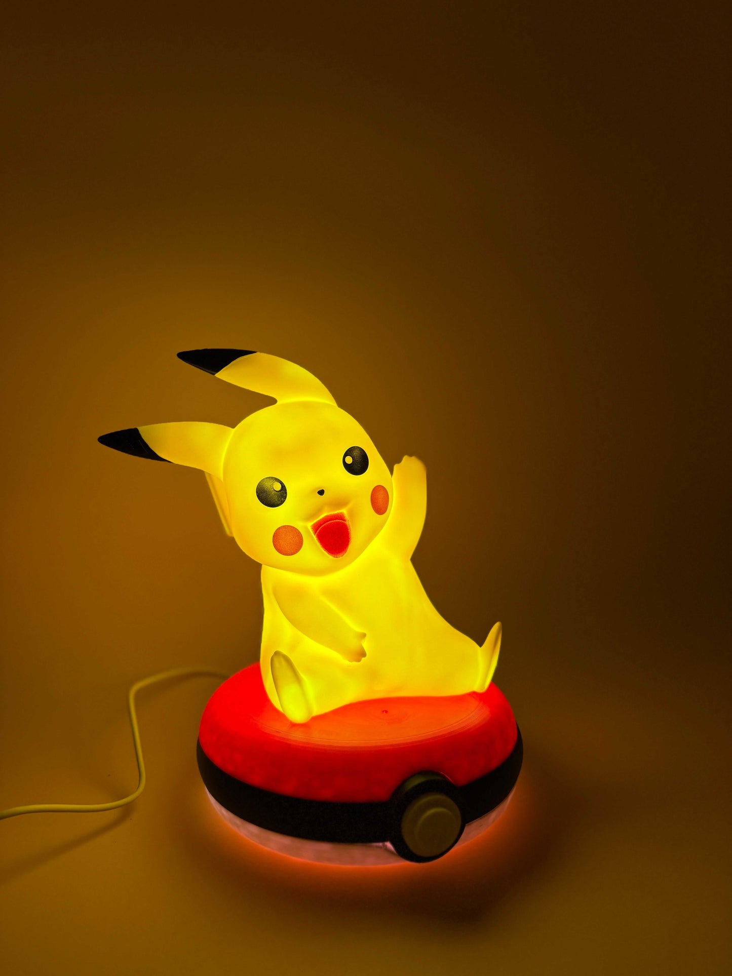 8" Pikachu Pokeball desk lamp with USB cord, glowing yellow Pikachu on red Pokeball base.
