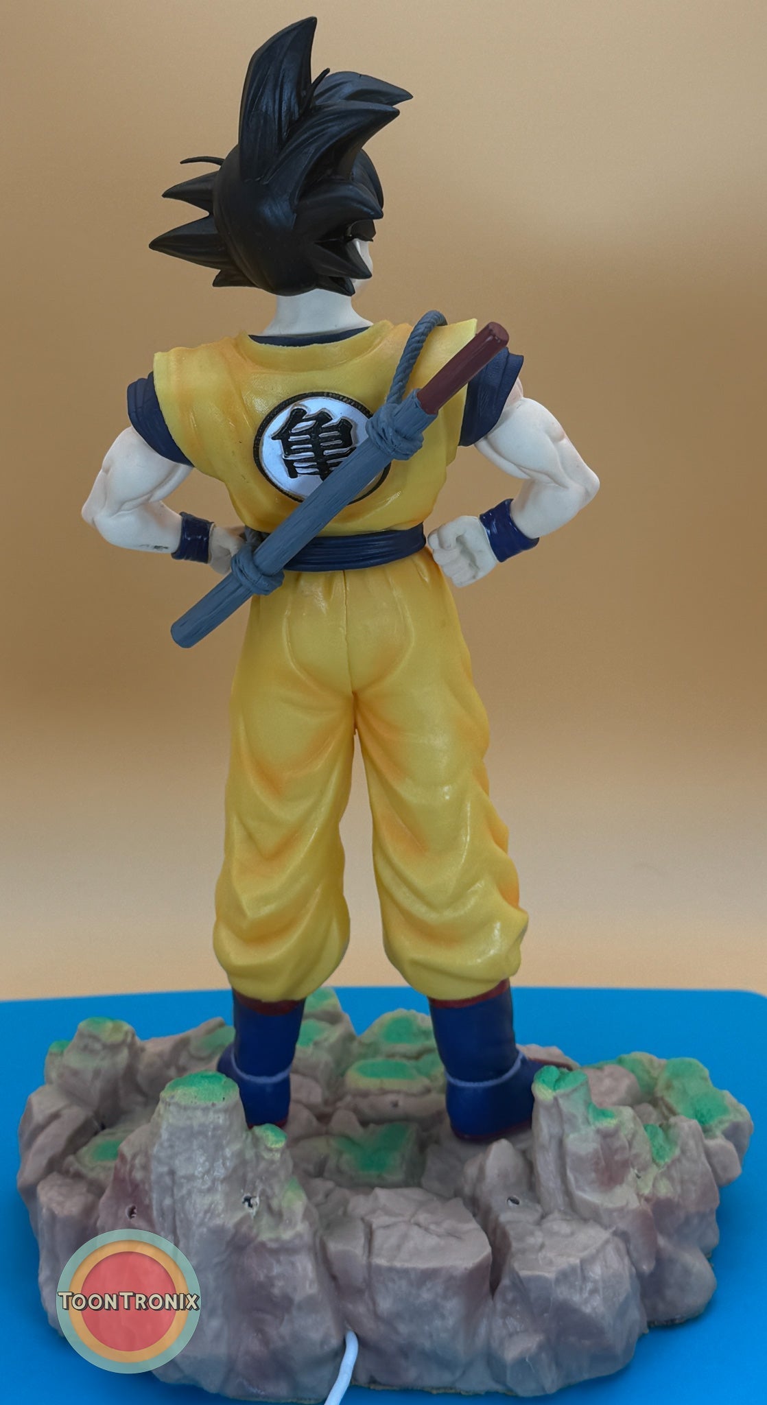 12" 1 FT Goku Statue USB desk lamp showing back view of Goku in yellow outfit standing on rocky base with sword on back