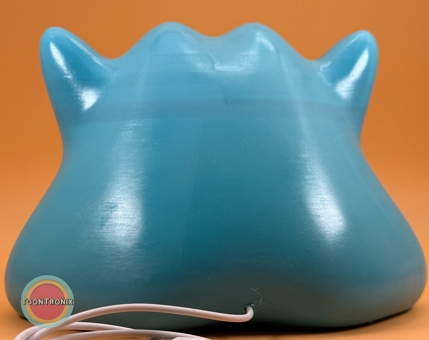 Limited 6-inch blue Ditto Pokemon statue USB desk lamp with wood-like finish and built-in cord, showing back view