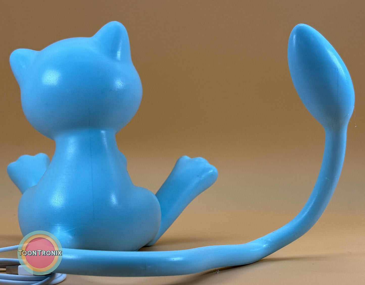 6 inch tall 11 inch wide shiny blue Mew Pokémon statue USB desk lamp with wood-like finish
