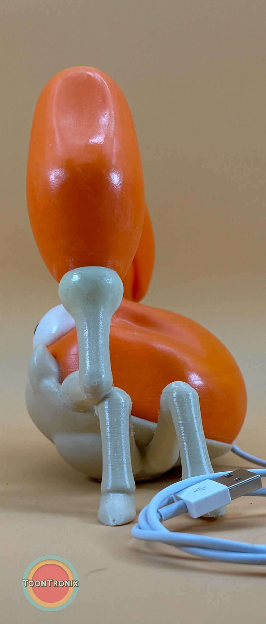 6" Krabby Desk Lamp with USB cord and wood-like finish on a beige background