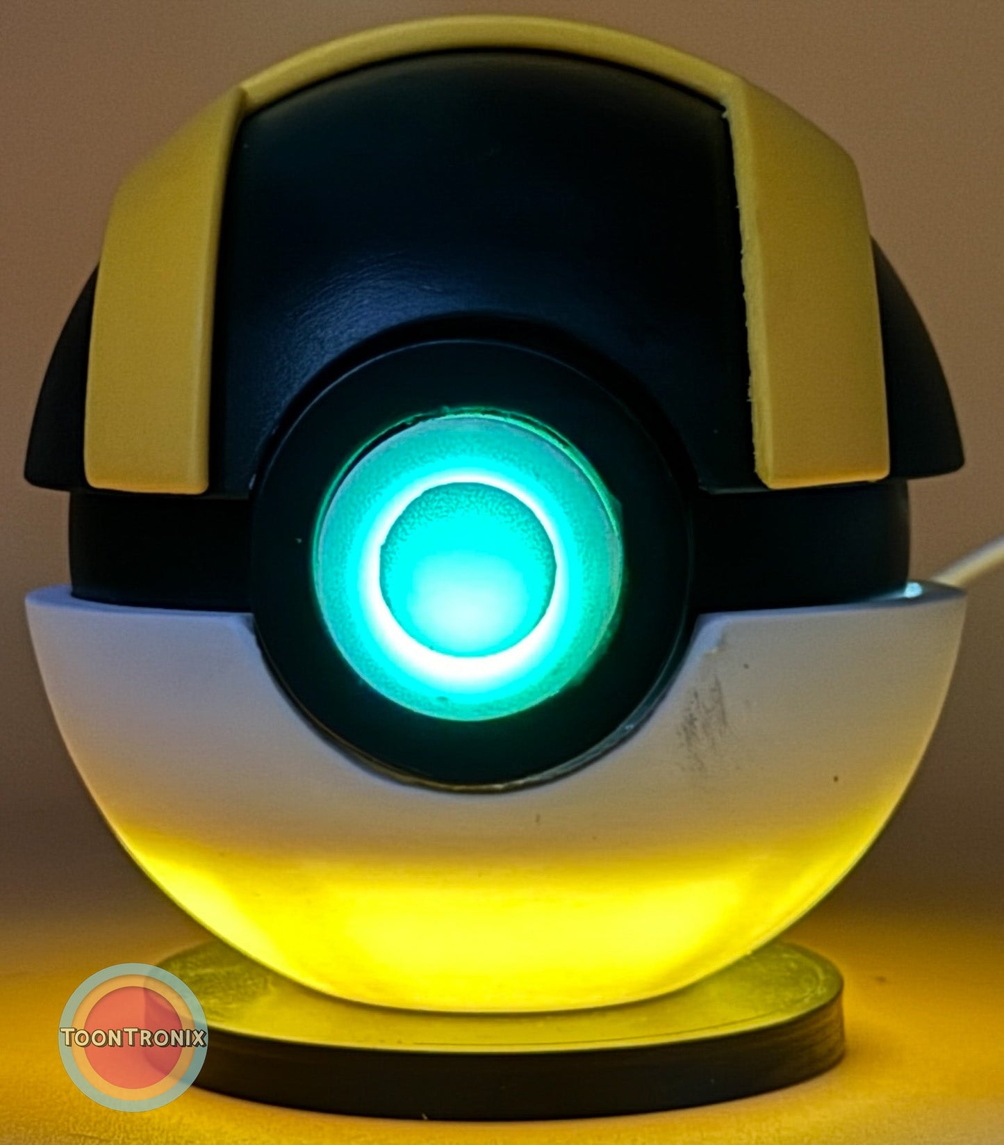 Glowing 4.5" Pokeball Premier Ball USB desk lamp with wood-like finish and yellow accent light