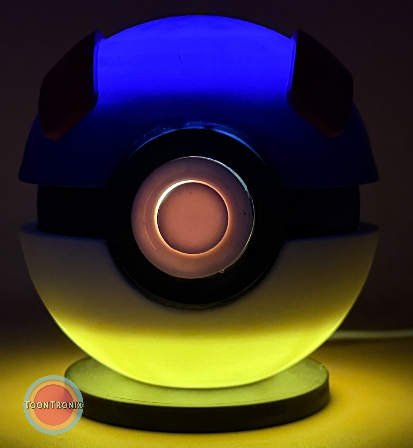 4.5" and 5.8" Pokeball Premier Ball USB desk lamp with wood-like finish glowing blue and yellow