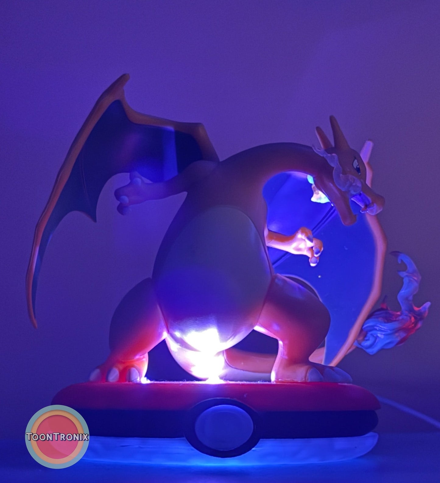 4" Charizard Pokemon statue USB desk lamp glowing with blue and purple light on Pokeball base