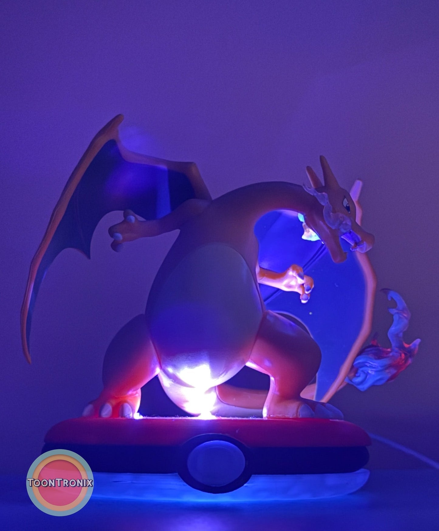 4" Charizard Pokemon statue desk lamp with USB cord and blue lighting on Pokeball base