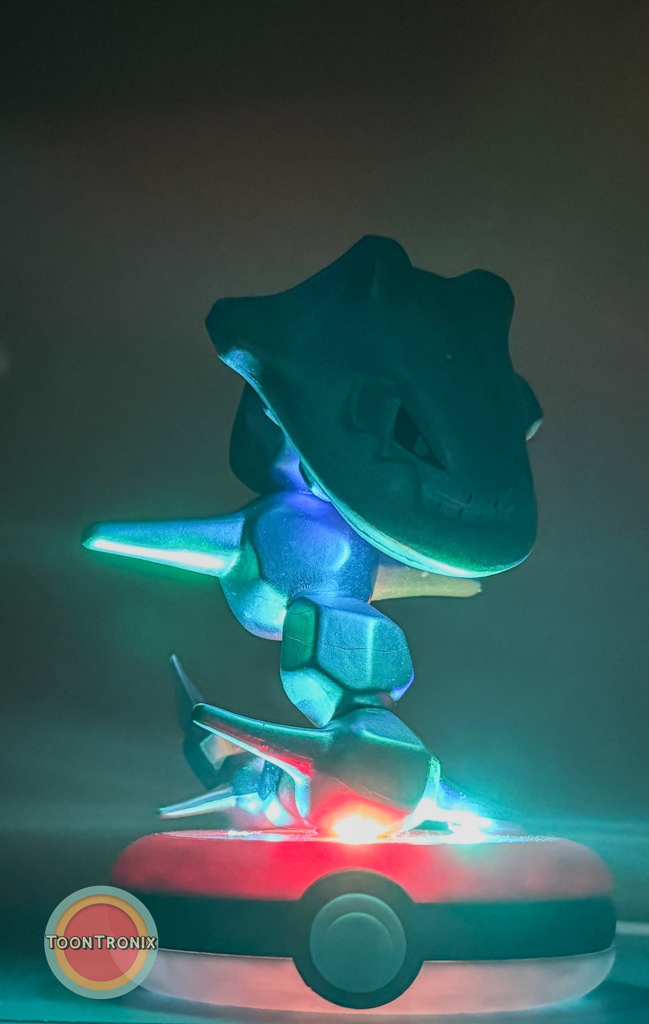 4" Steelix Pokemon Statue USB Desk Lamp glowing with blue and red light on a Pokeball base