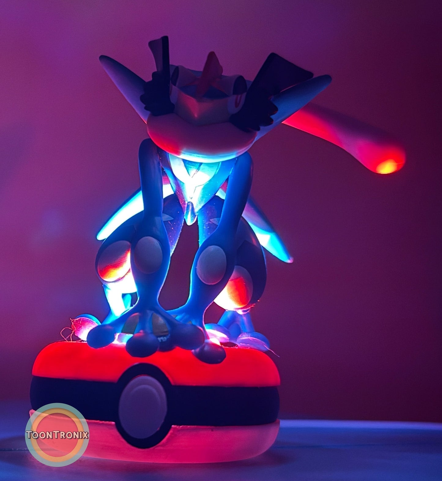 3" Greninja Pokémon statue USB desk lamp glowing blue and red on Poké Ball base