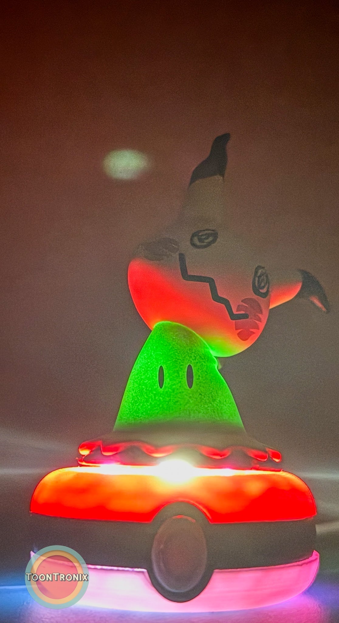 3" Mimikyu Pokemon statue USB desk lamp glowing in red and green colors on a Pokeball base