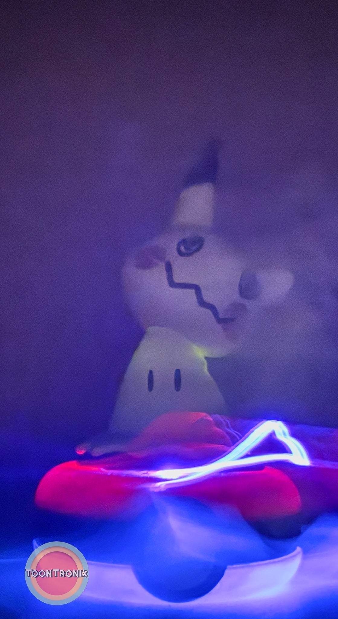 3" Mimikyu Pokemon statue USB desk lamp glowing with soft blue and red light on a Pokeball base