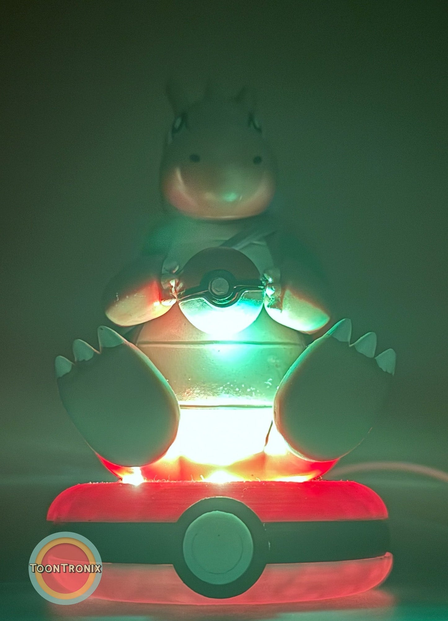 5" Dragonite Pokemon statue USB desk lamp glowing with red and green light on a Pokeball base