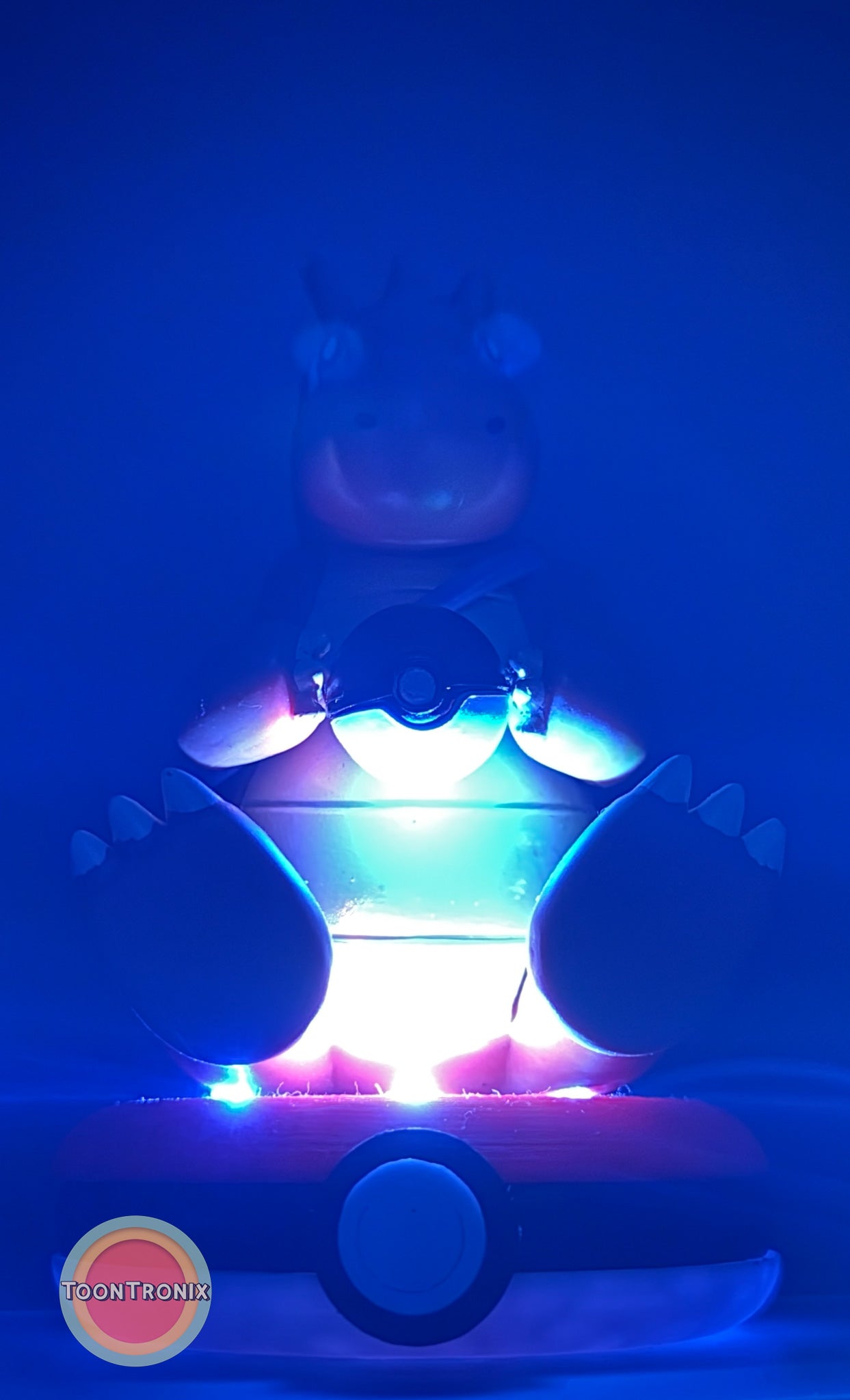 5" Dragonite Pokemon statue USB desk lamp glowing with blue and purple light on Pokeball base