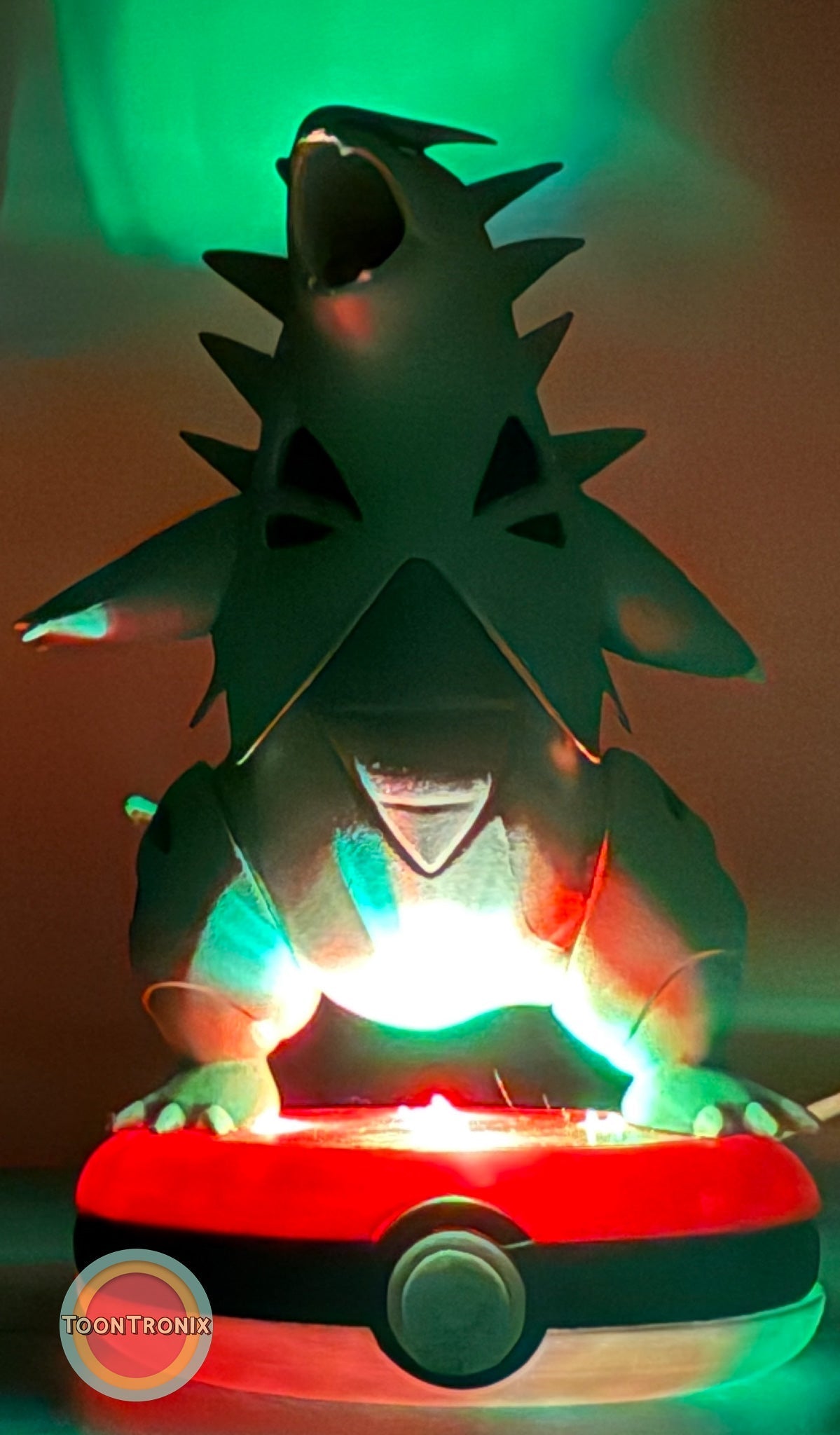 5" Tyranitar Desk Lamp with USB cord glowing on Pokeball base