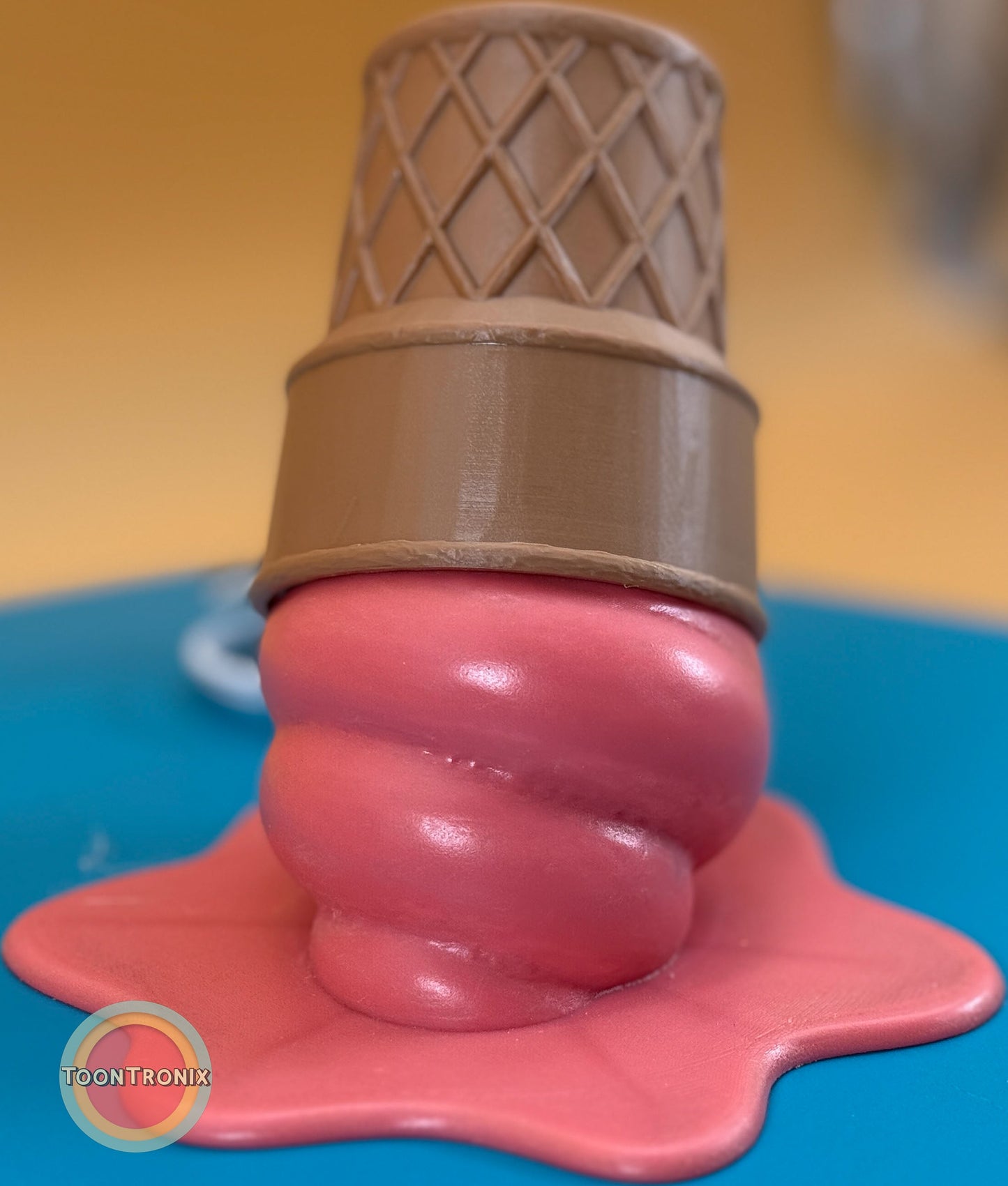 Melting pink ice cream cone desk lamp with wood-like finish and built-in USB cord.