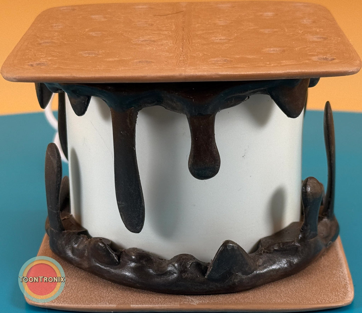 Retro cartoon style smores desk lamp with melting chocolate and toasted marshmallow design on a blue background