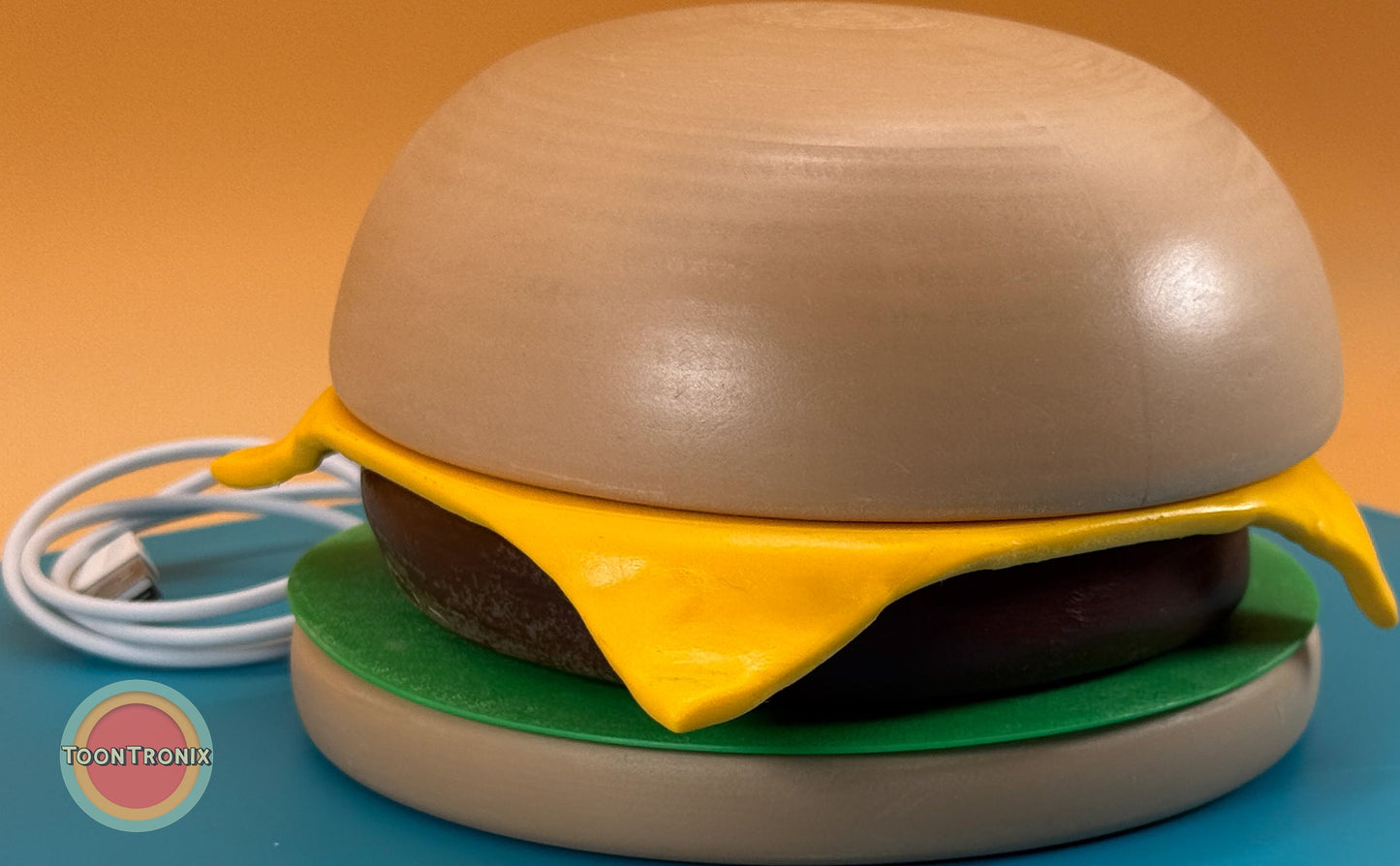 6 or 9 inch burger-shaped desk lamp with wood-like finish and built-in USB cord on blue surface
