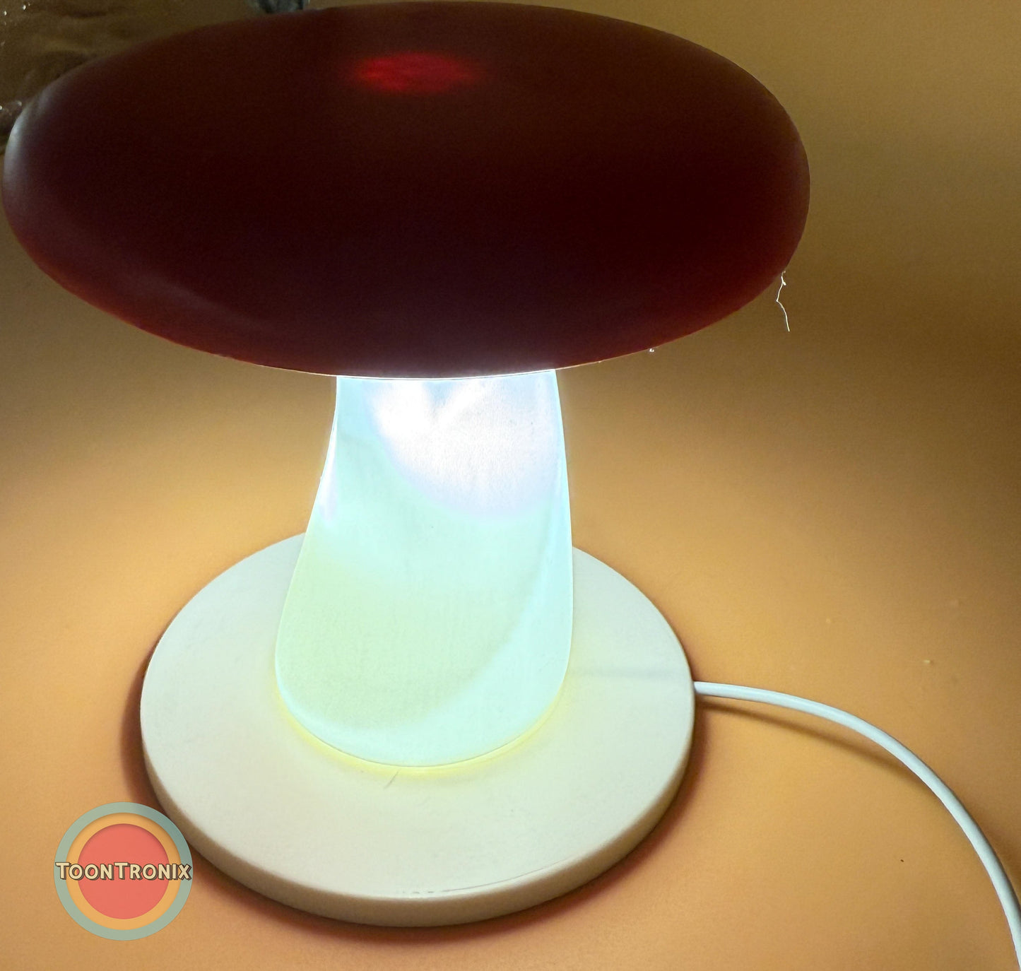 6" or 9" mushroom-shaped desk lamp with glowing white stem and red cap on round base with USB power cord