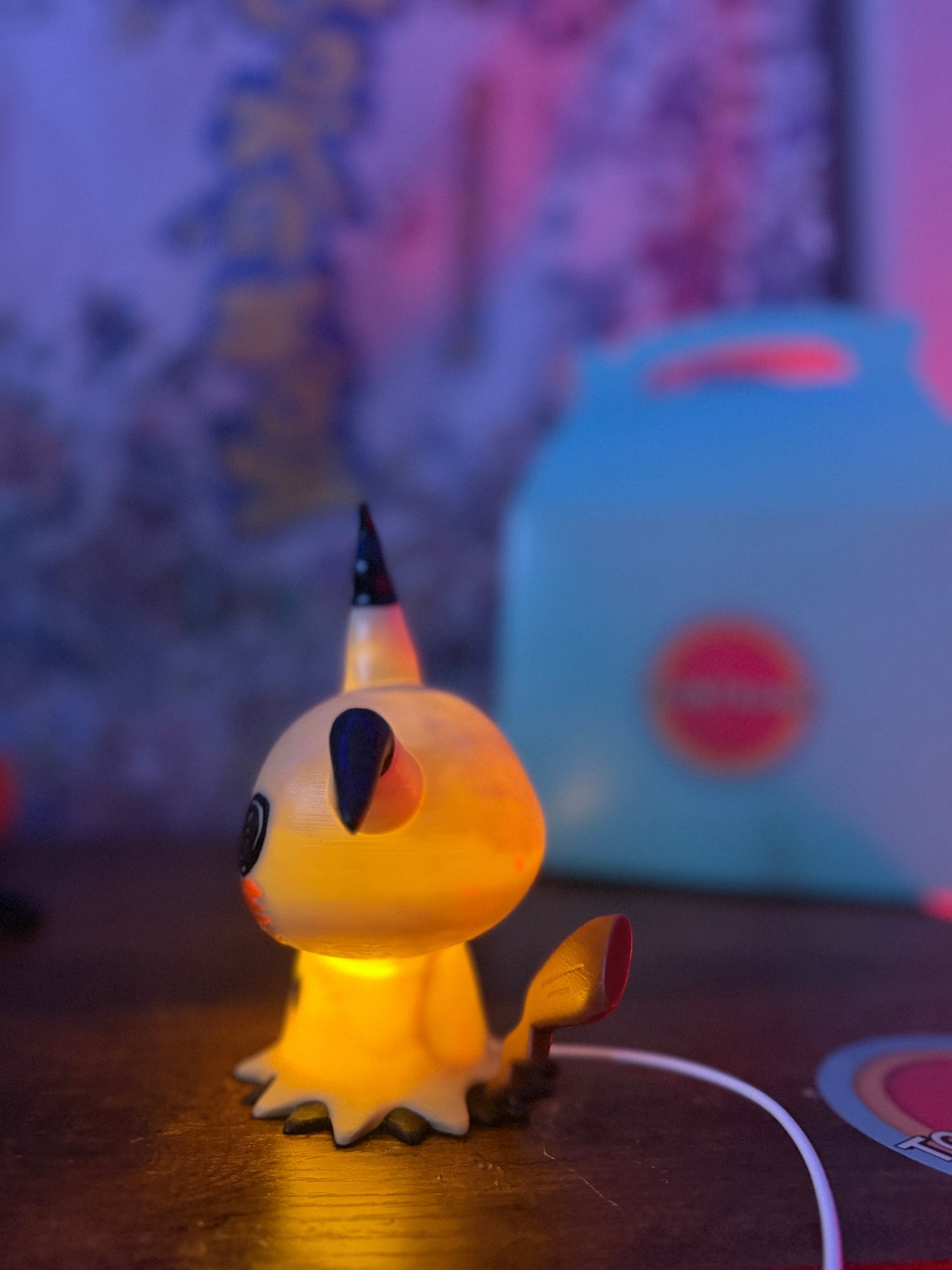 6" Mimikyu Pokemon statue desk lamp with USB cord and wood-like finish glowing yellow light