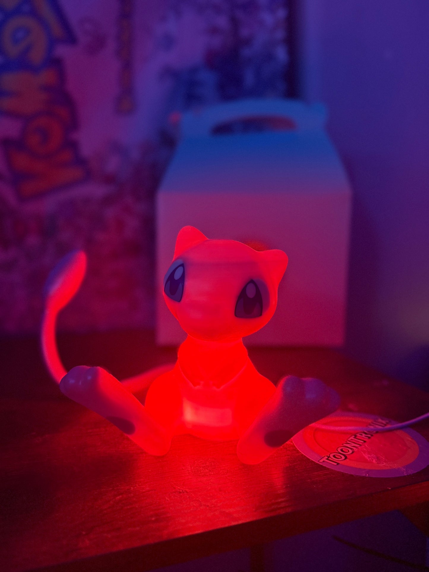 6" tall Mew Pokemon statue desk lamp with built-in USB, glowing red light, wood-like finish.
