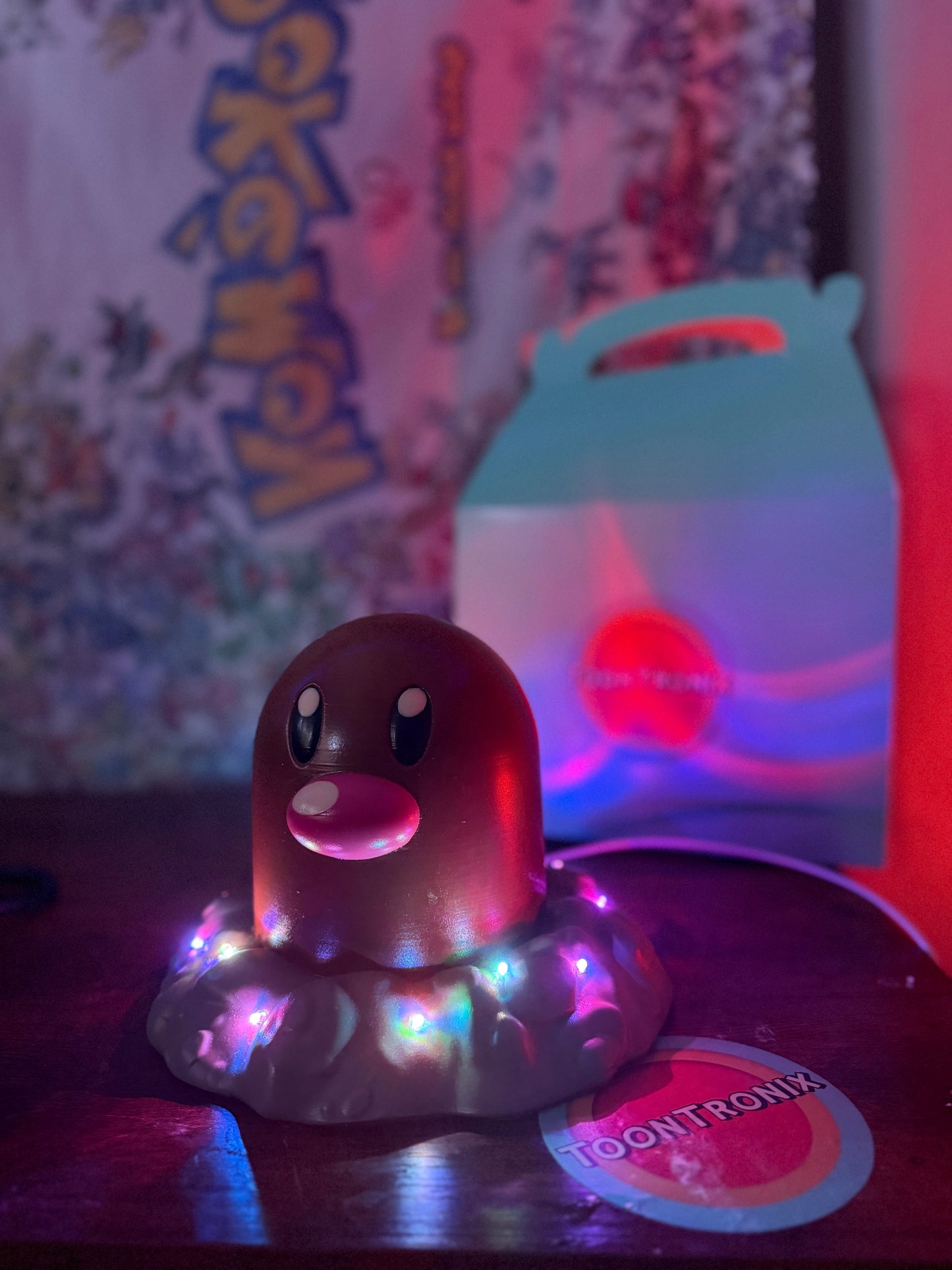 6" tall Diglett Pokemon statue desk lamp with LED lights and USB cord on wooden surface