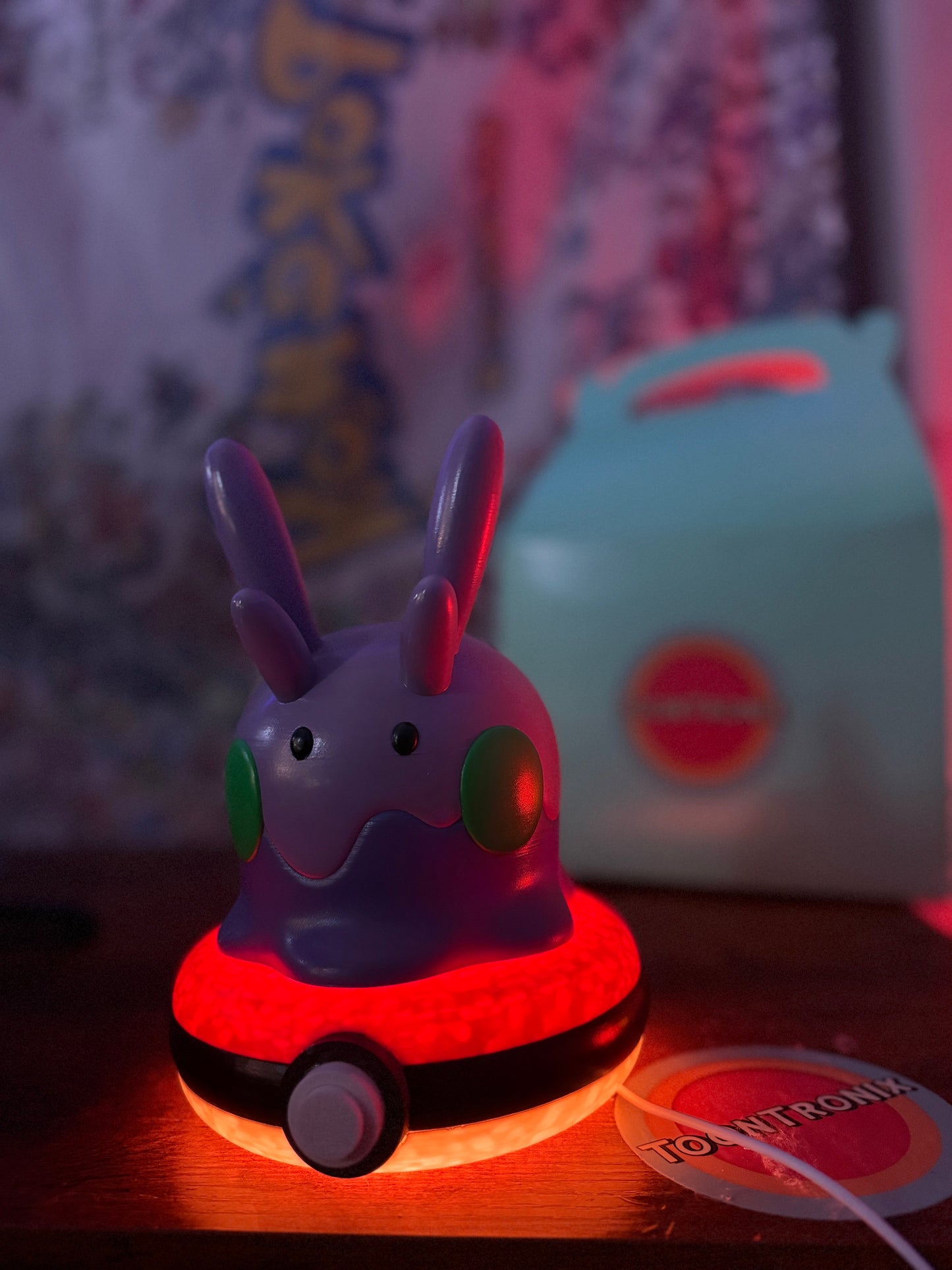 8" Goomy Desk Lamp glowing red on Poké Ball base with USB cord, wood-effect finish, limited edition Pokemon figure light