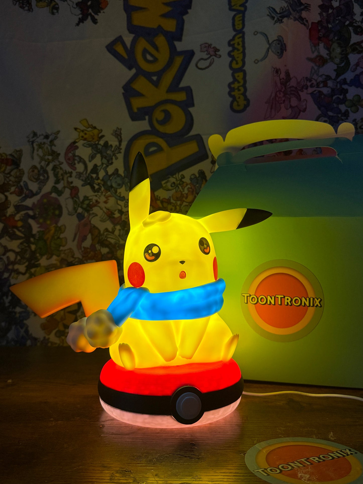 Winter Pikachu Pokeball USB LED desk lamp figure with glowing yellow Pikachu wearing blue scarf on red and white Pokeball base