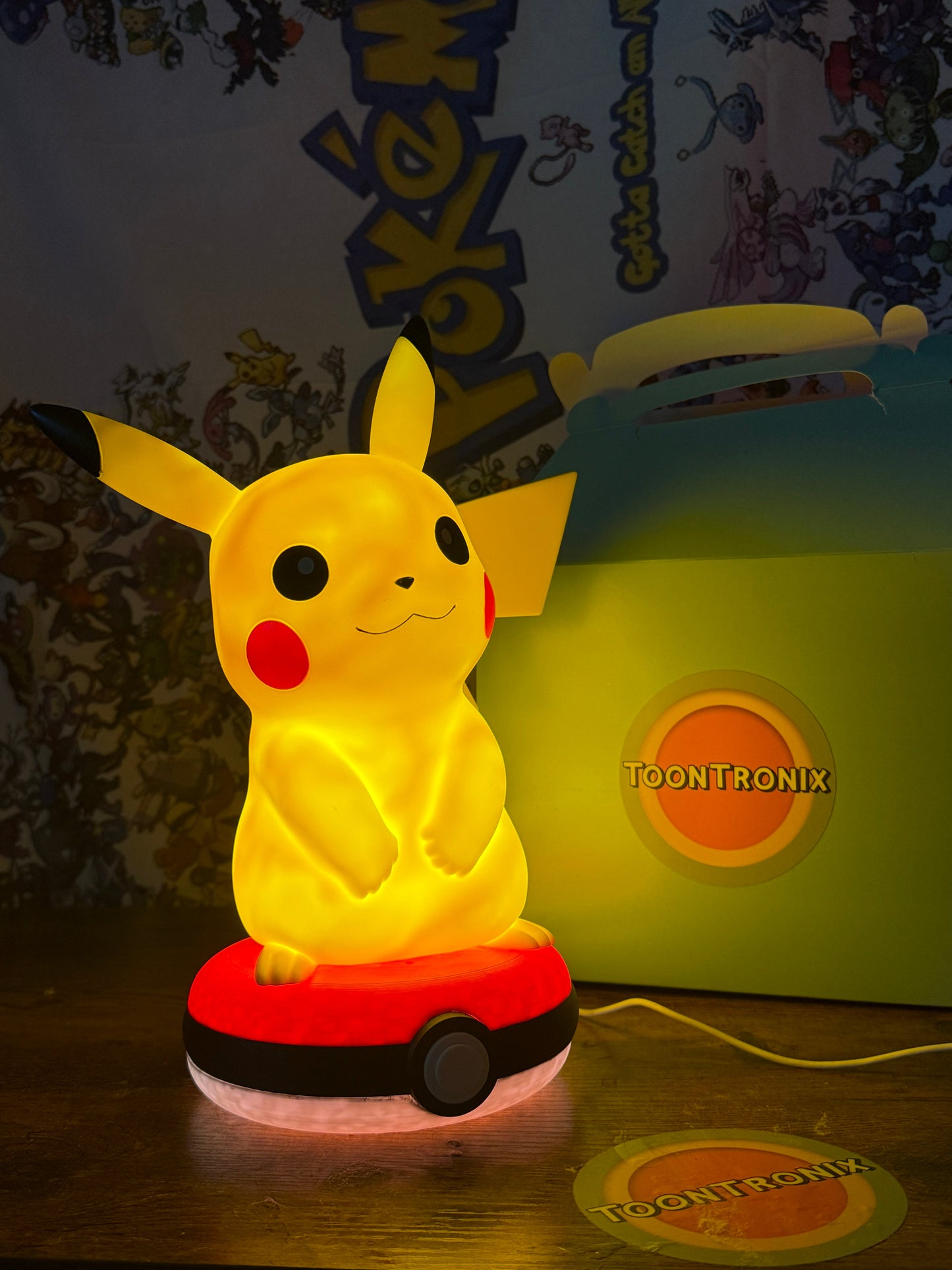 12” Pikachu Pokeball LED desk lamp with built-in USB cord, glowing yellow Pikachu figure on a Pokeball base