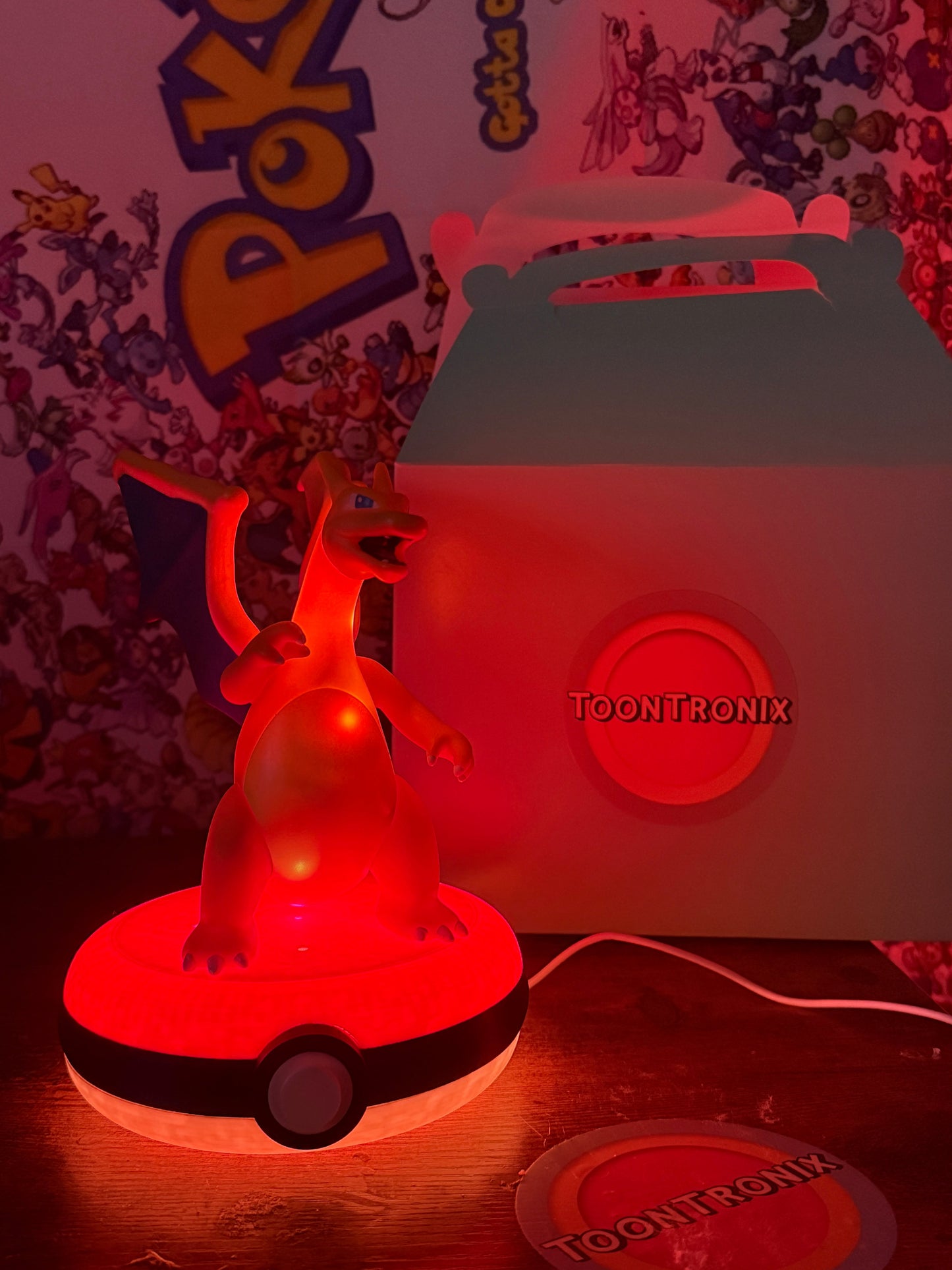 8-inch Charizard Pokeball desk lamp with built-in USB, glowing red LED light, and Pokemon-themed background