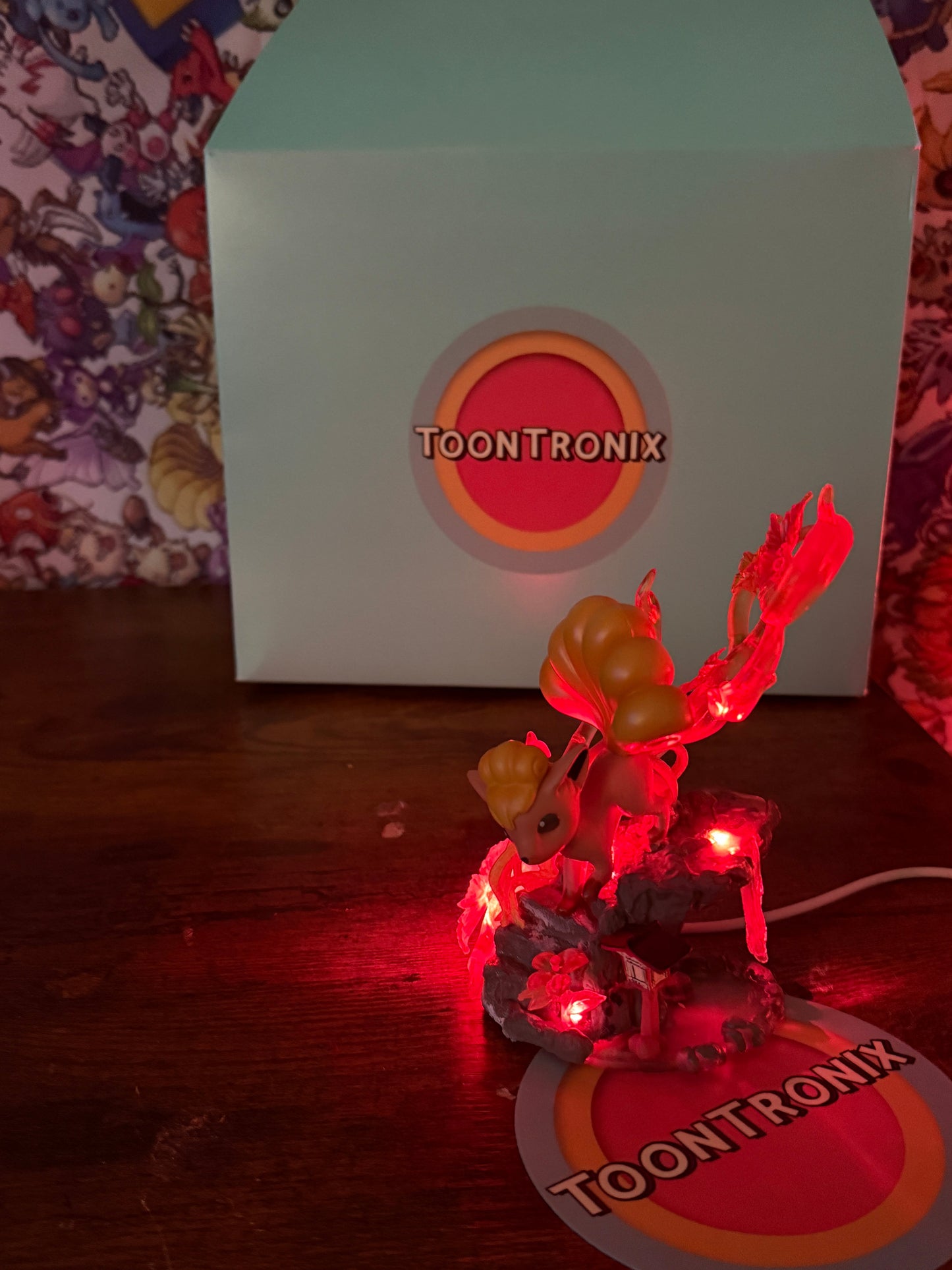 5" Vulpix statue LED desk lamp with USB cord glowing red on wooden surface